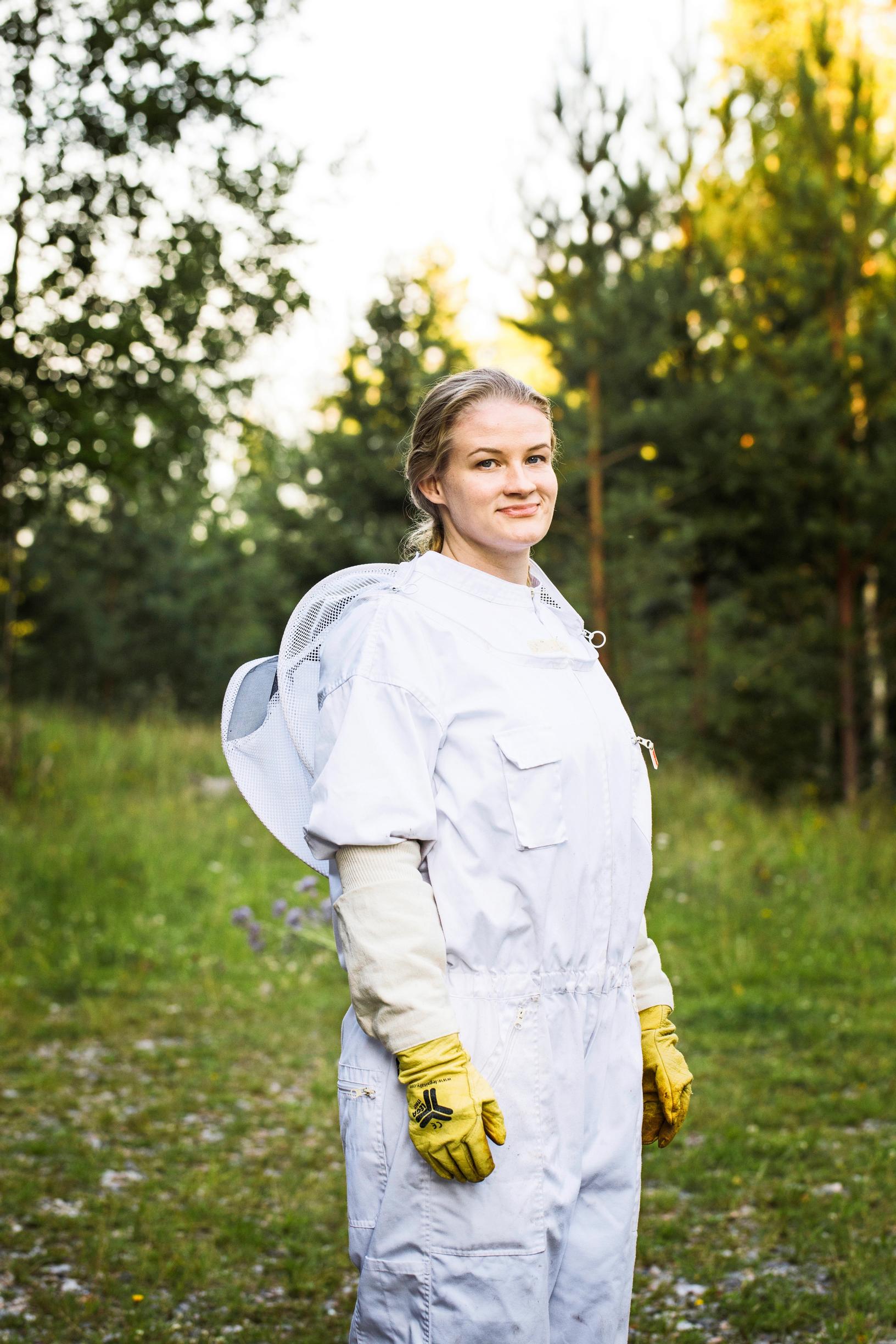 Beekeeper Nora Mäntysaari in her protective suit