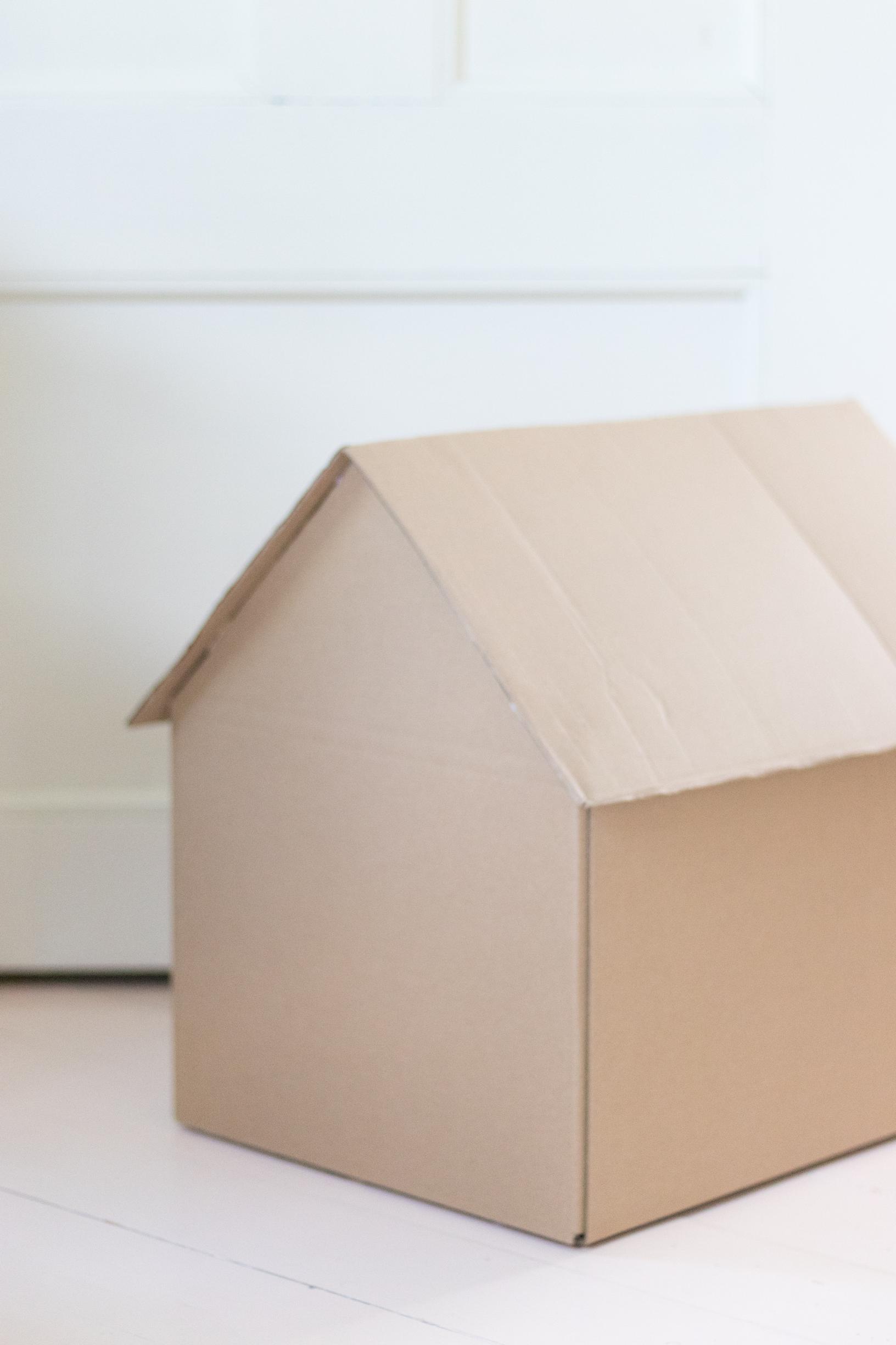 Shaping a cardboard box to look like a house