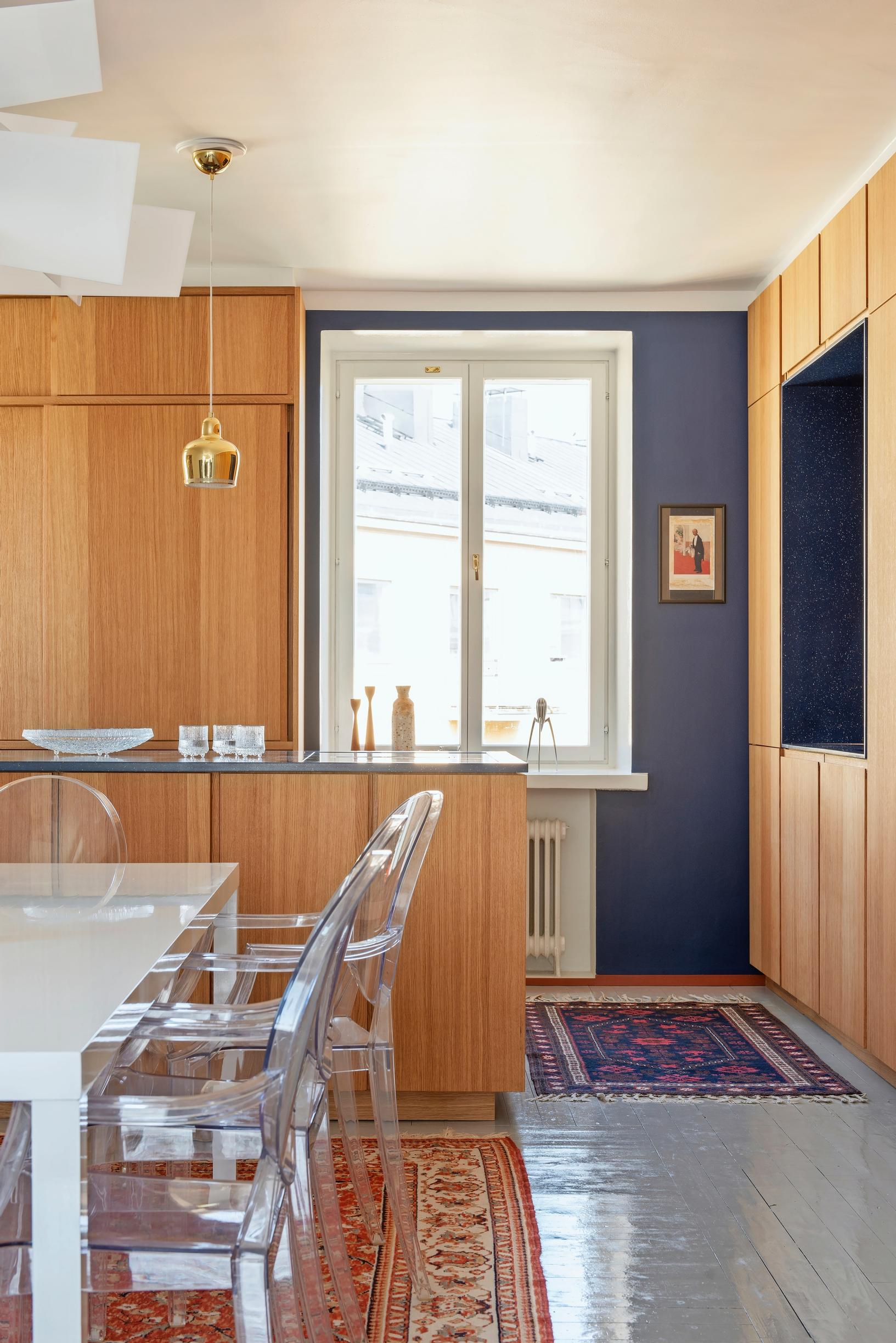 A custom oak kitchen cabinet on both sides of the window.