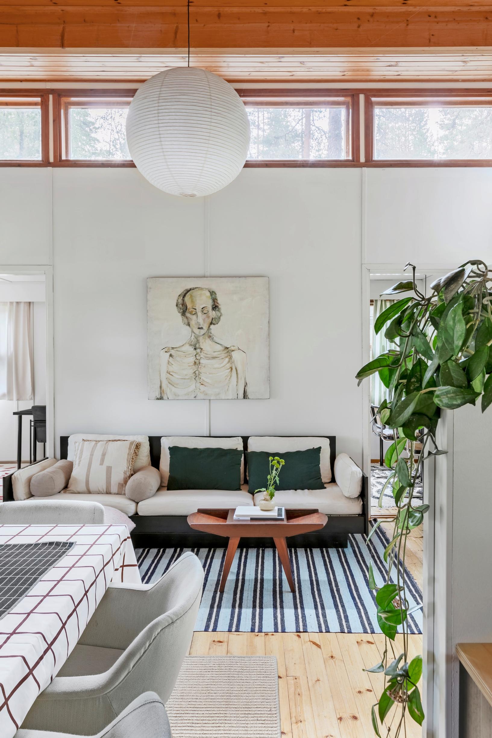 A sofa and table set in the living room of the summer cottage located in Vihti.
