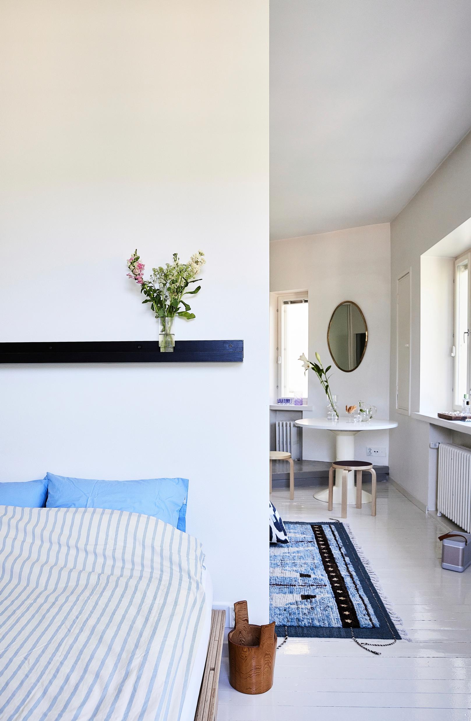 The bedroom is tucked behind the living room in its own serene space.