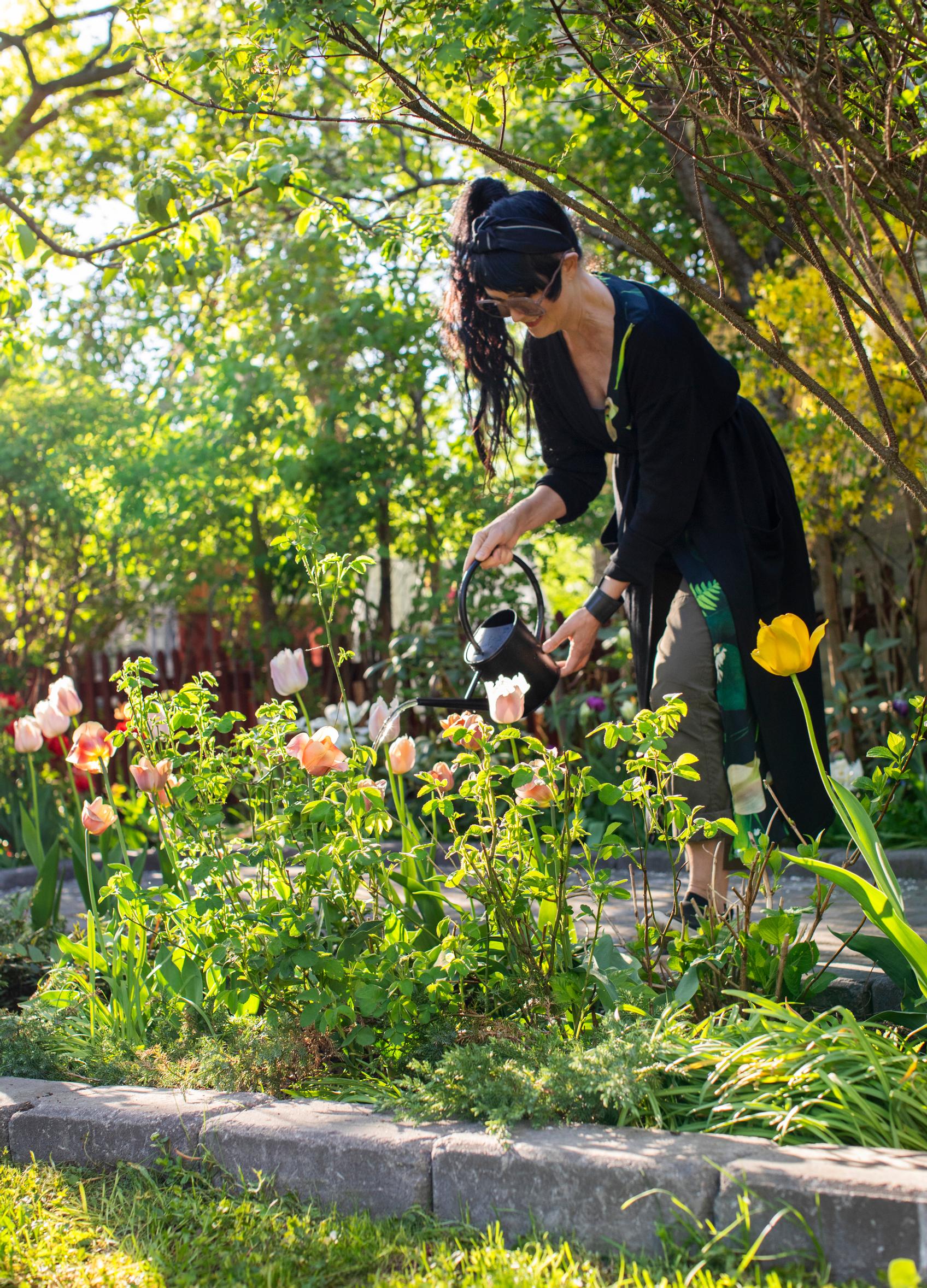 Maaretta Tukiainen watering her garden.