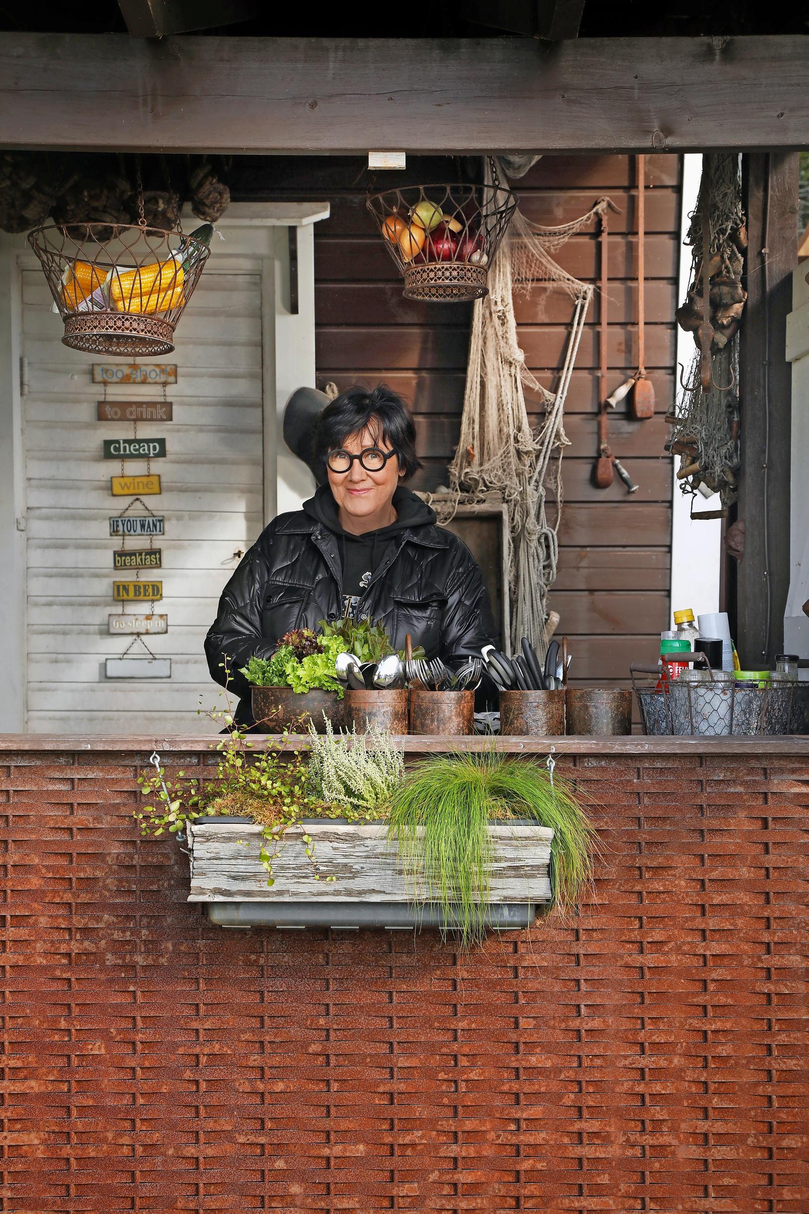 Sanna Parkkari and flower pots on the railing.