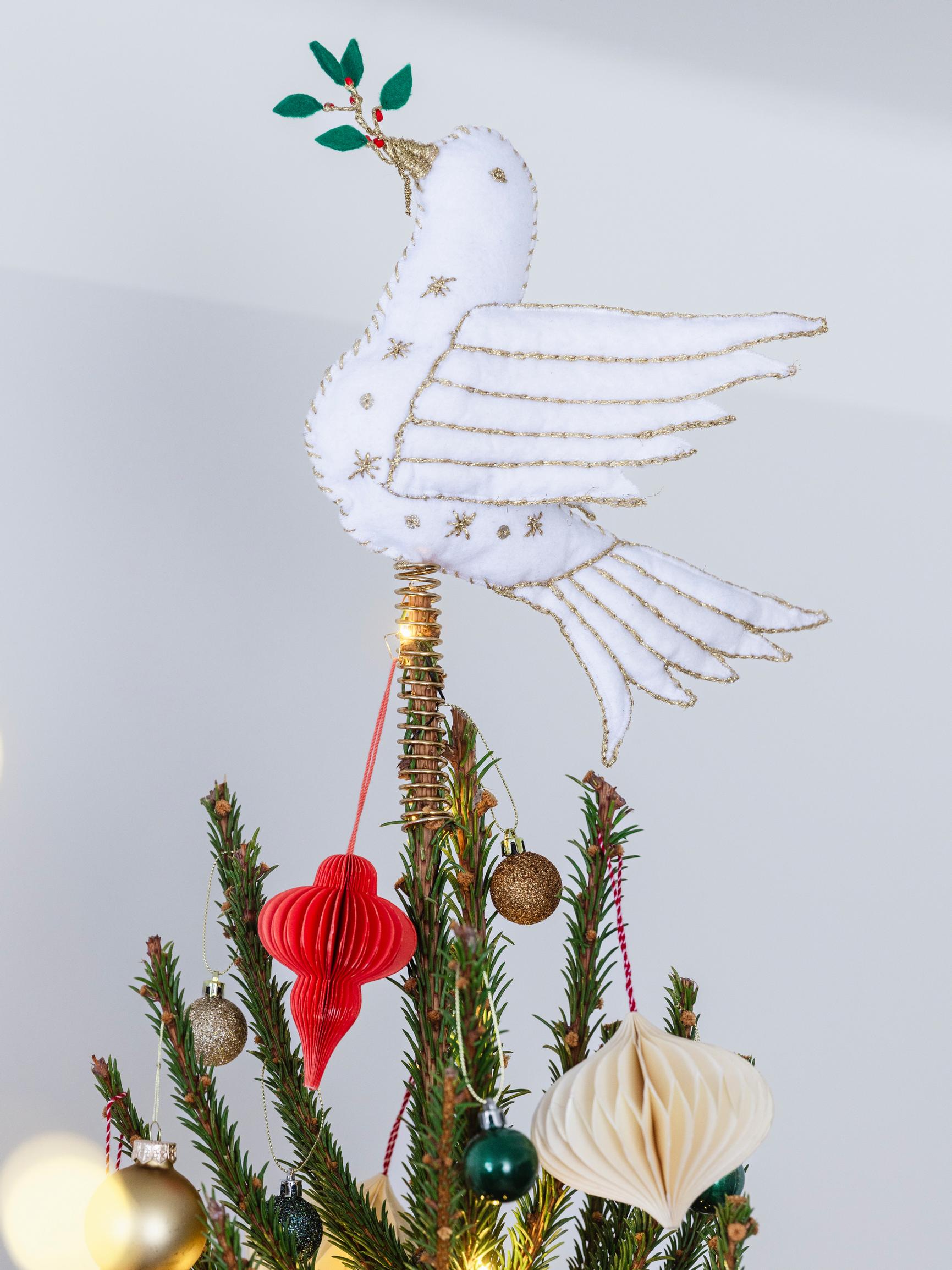 Craft a handmade white dove tree topper that carries a hint of hope