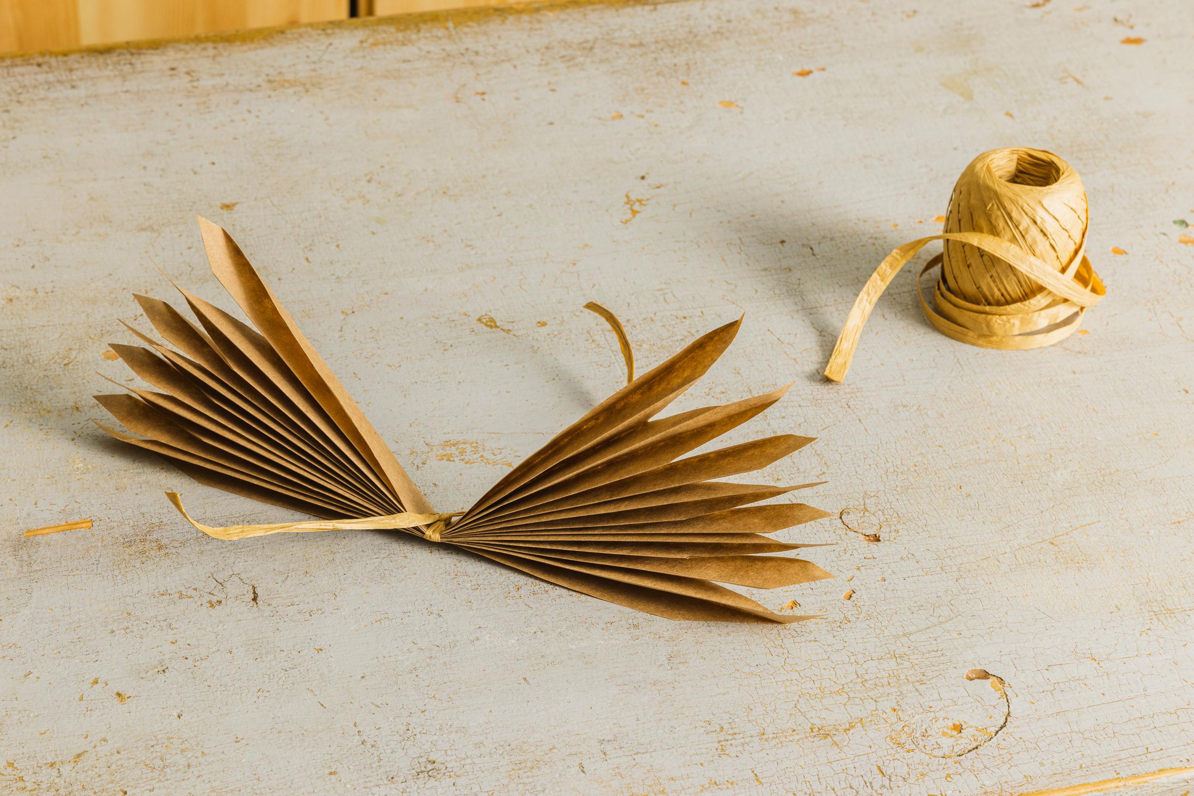 Layered star step 6: tie a string around the center of each folded piece.