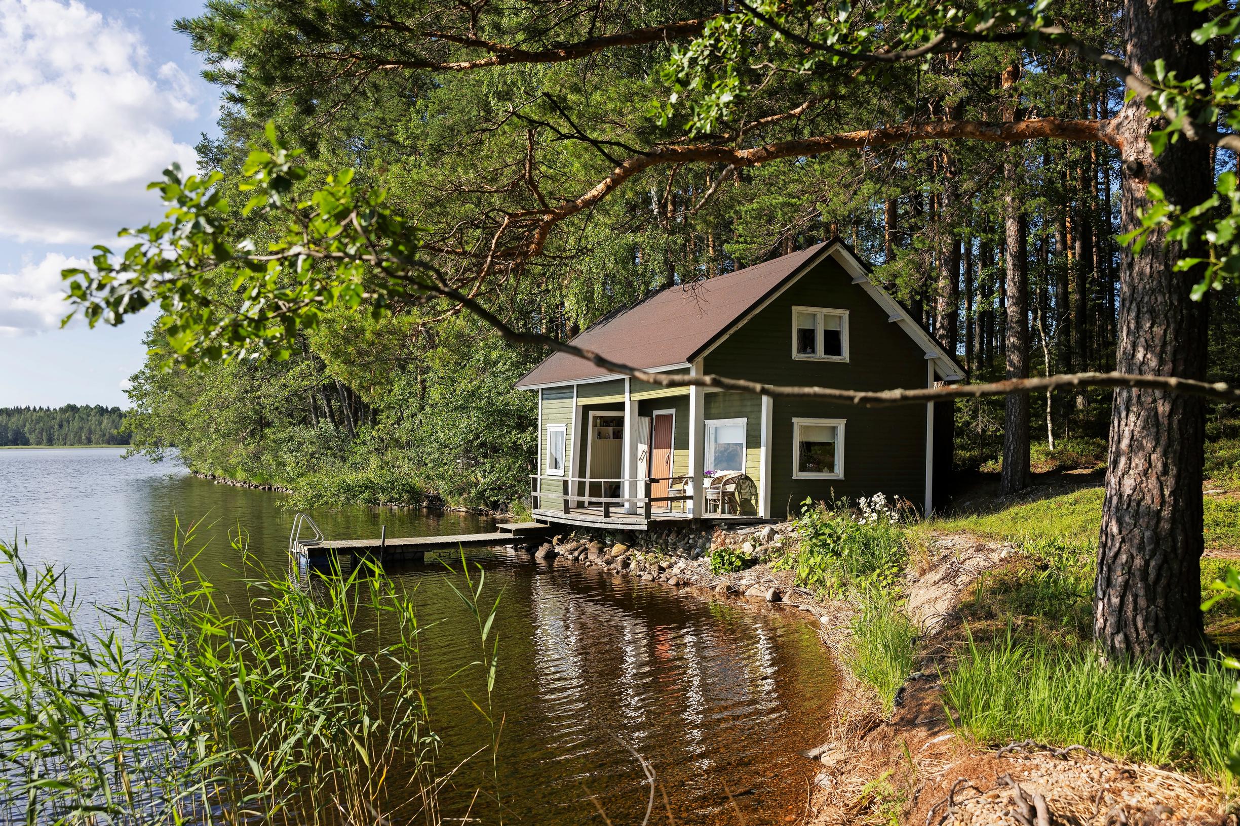 Lakeside sauna by the lake, dock, and forest