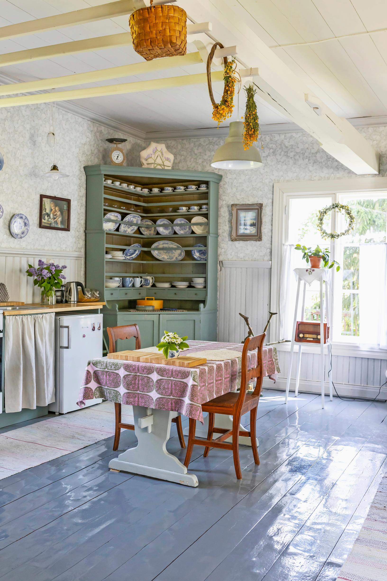 A large corner cabinet for dishes in an 1800s log house