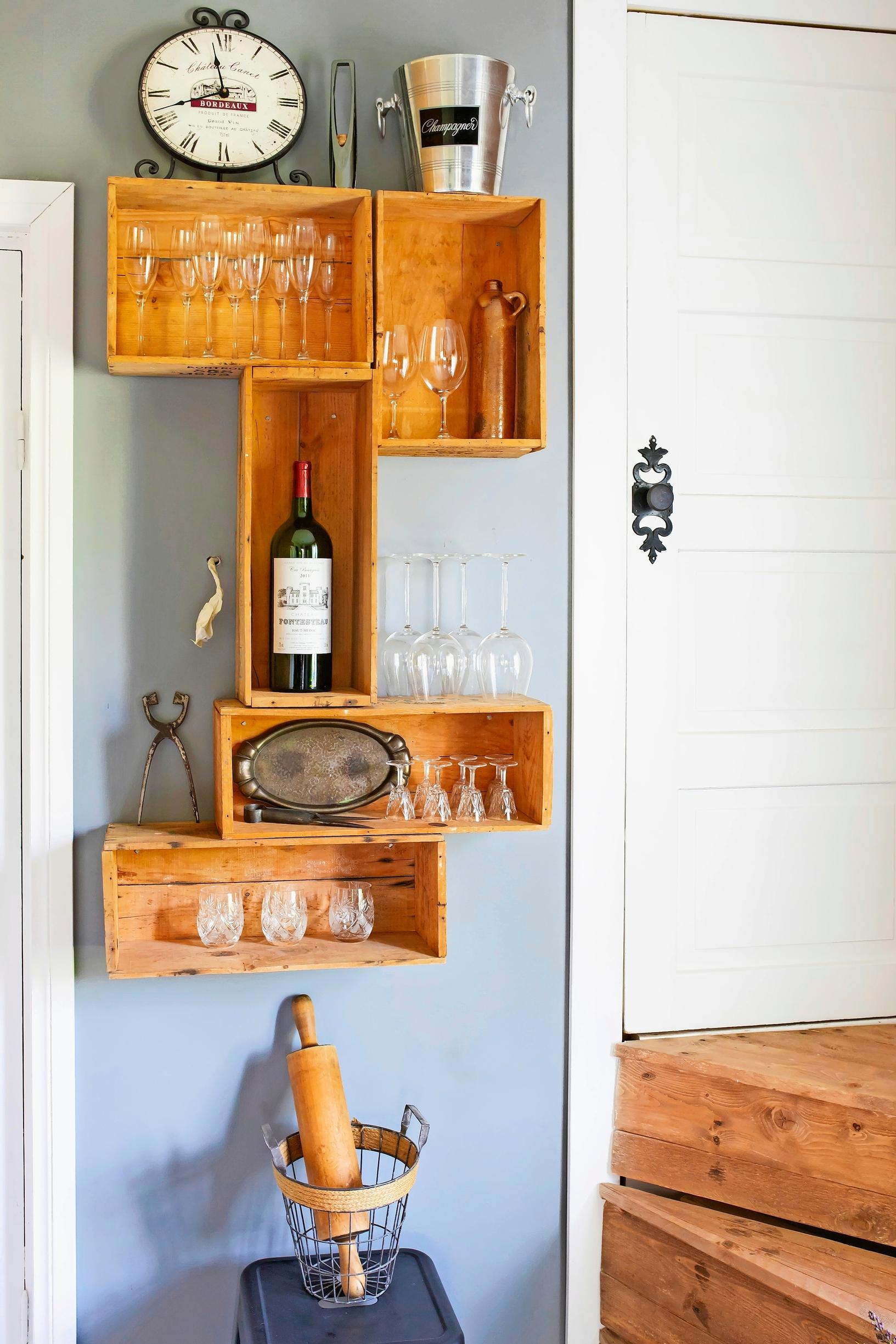 Kitchen shelf made from wooden wine boxes in an old log house