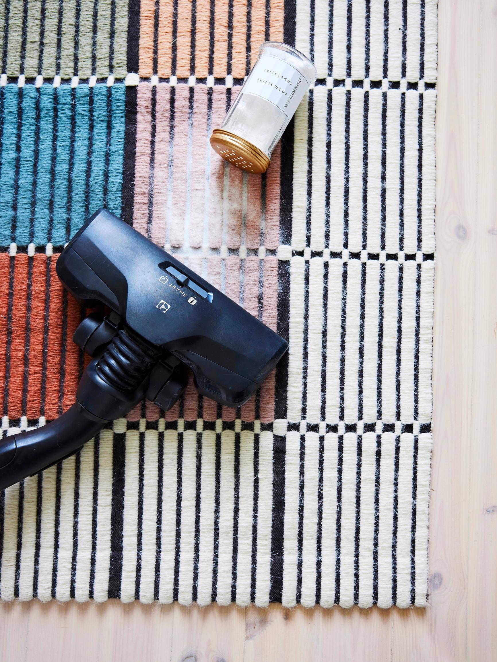 Freshen carpets and textiles with homemade vacuuming powder—all you need is baking soda and essential oil