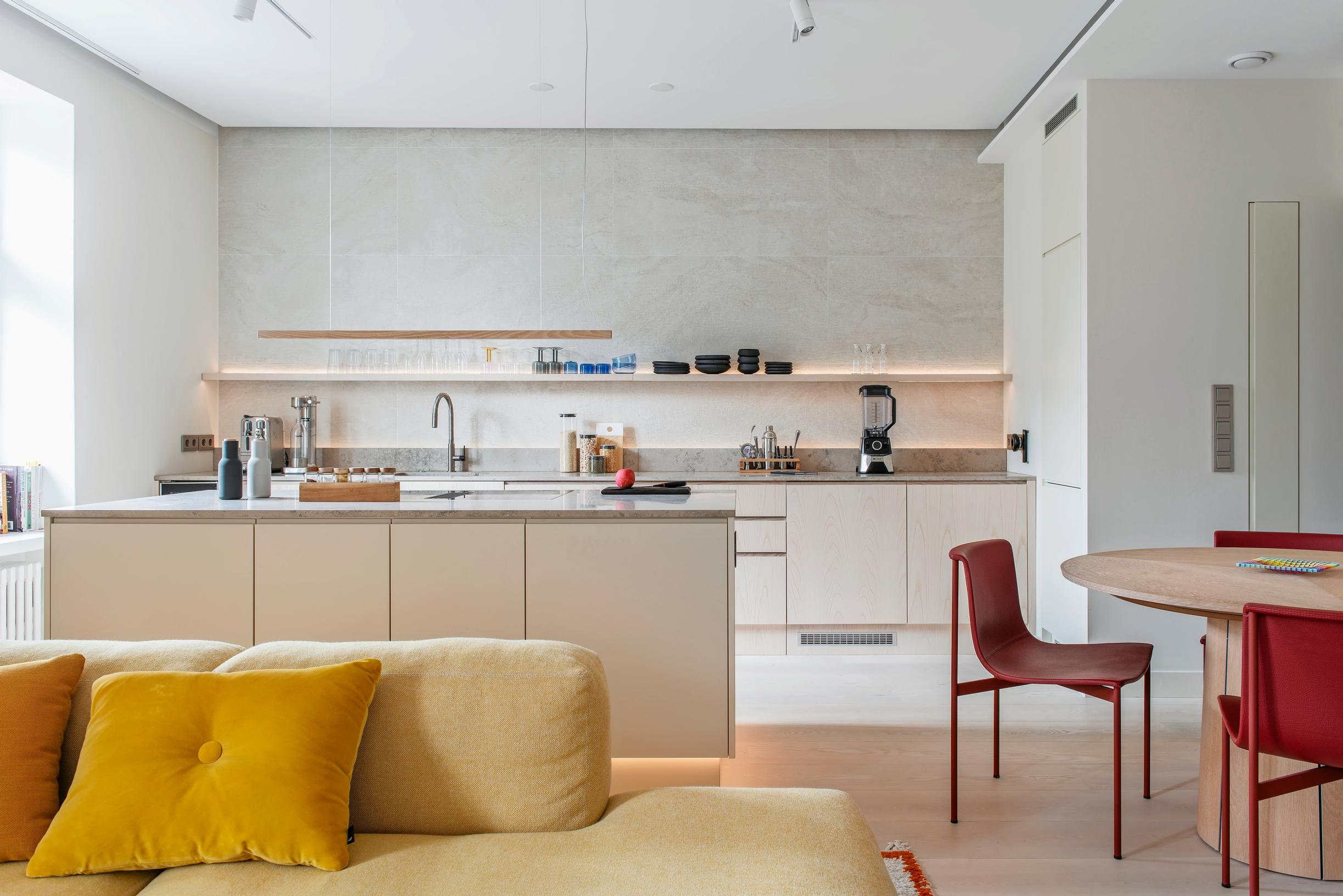 A spacious, bright kitchen where the cook can chat with someone on the sofa