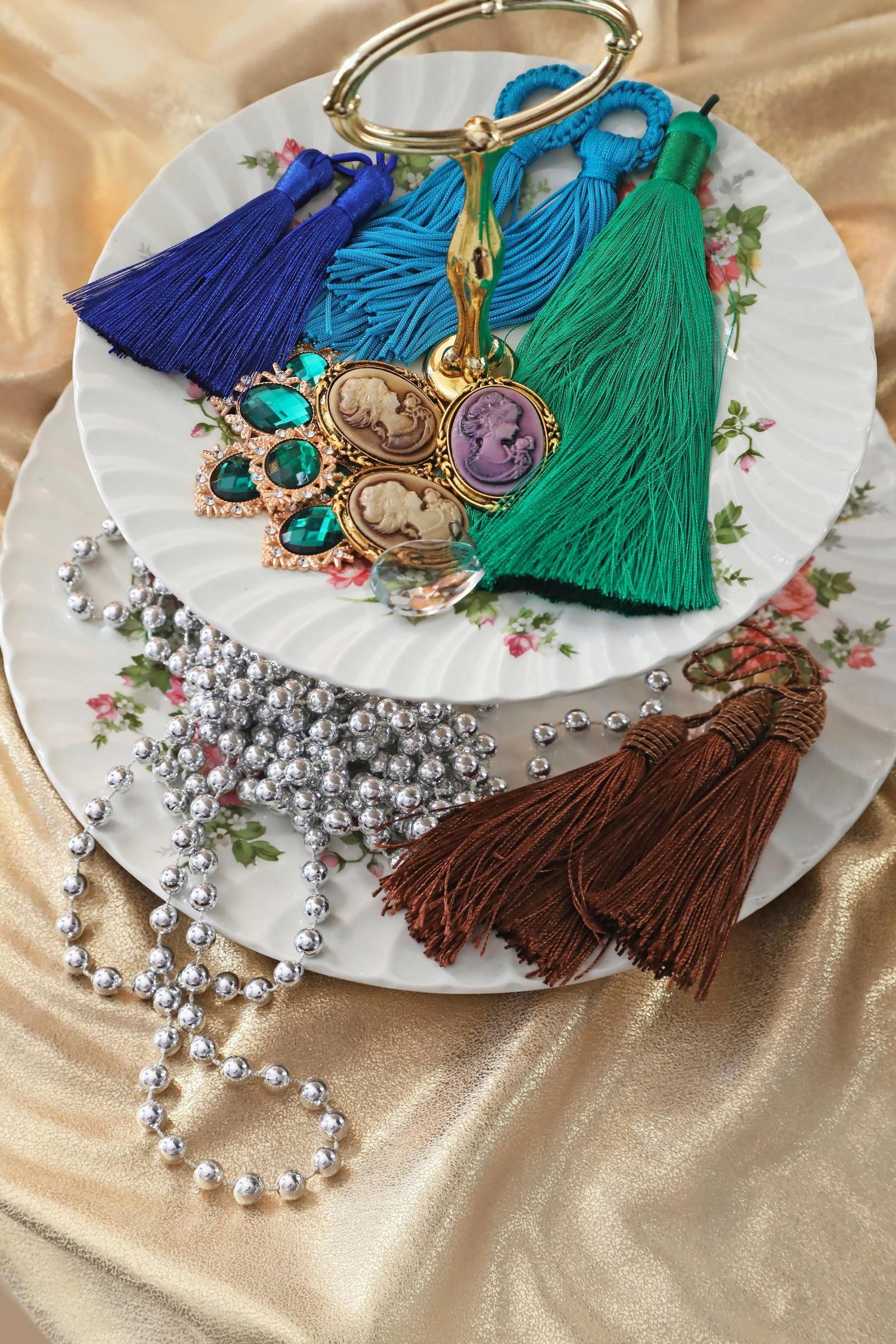 Old jewelry on a tiered stand.