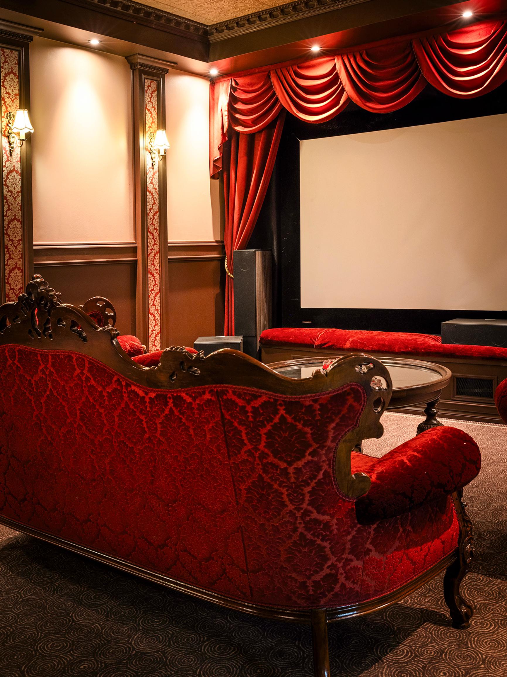 Garage turned into a red velvet and gold-saturated entertainment center! Mikko and Annastina’s home movie theater is a dream come true
