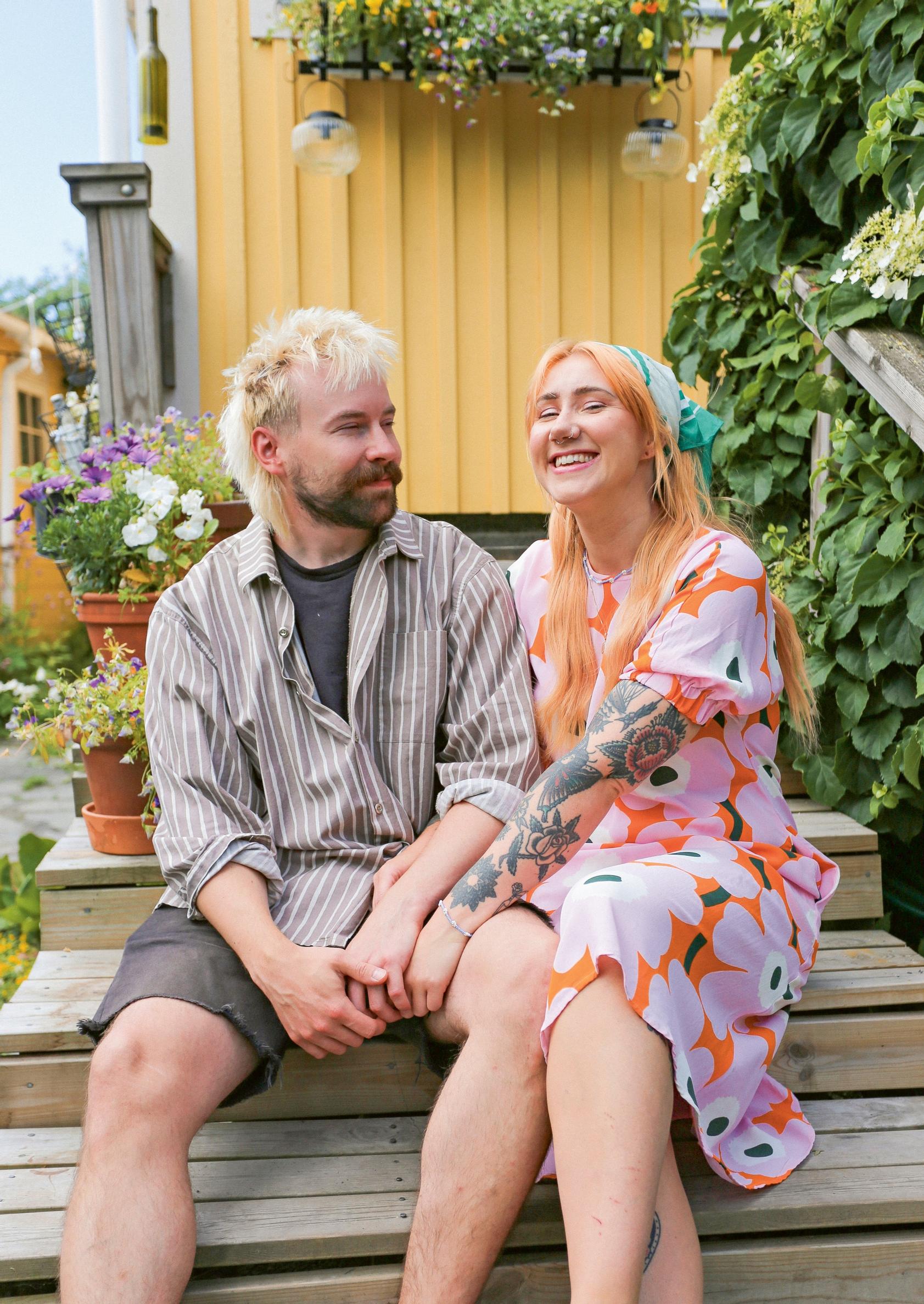 Hanna Paananen and Aksu sitting on the steps of their allotment garden cottage