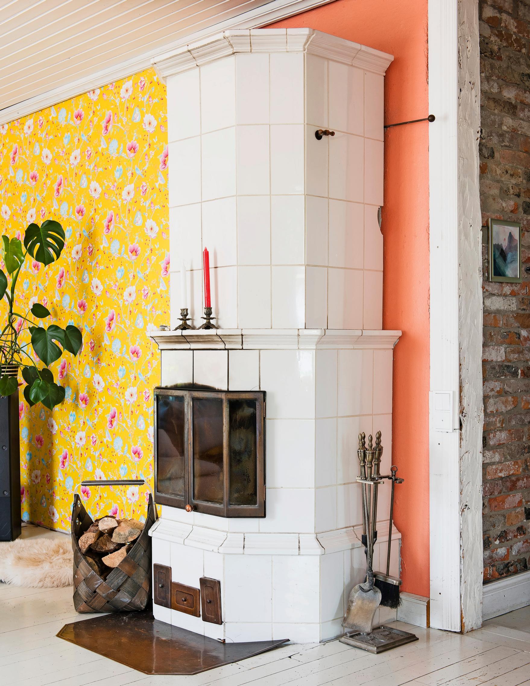 Photo of the tile stove and yellow floral wallpaper.