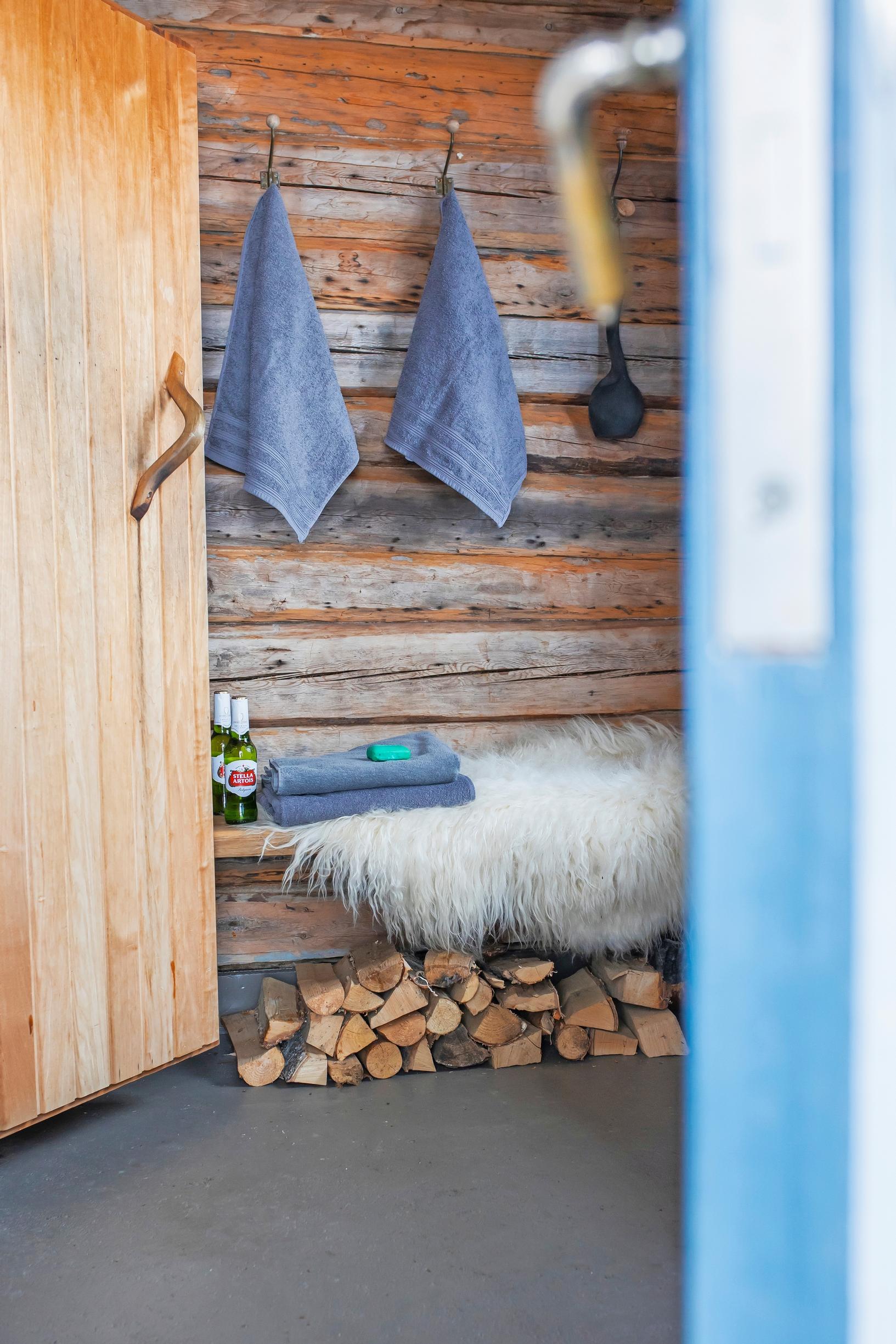 Blue-gray towels in a changing room with log walls
