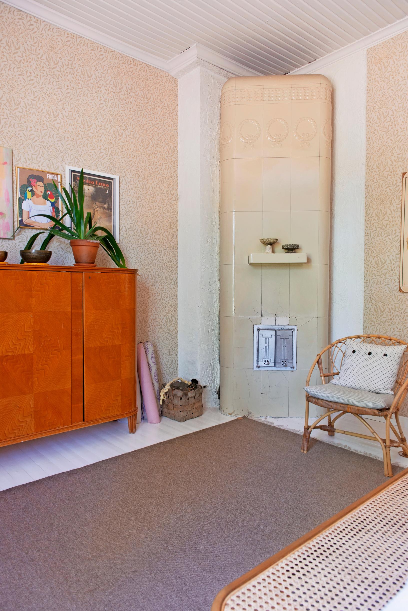 A cabinet and an old tiled stove