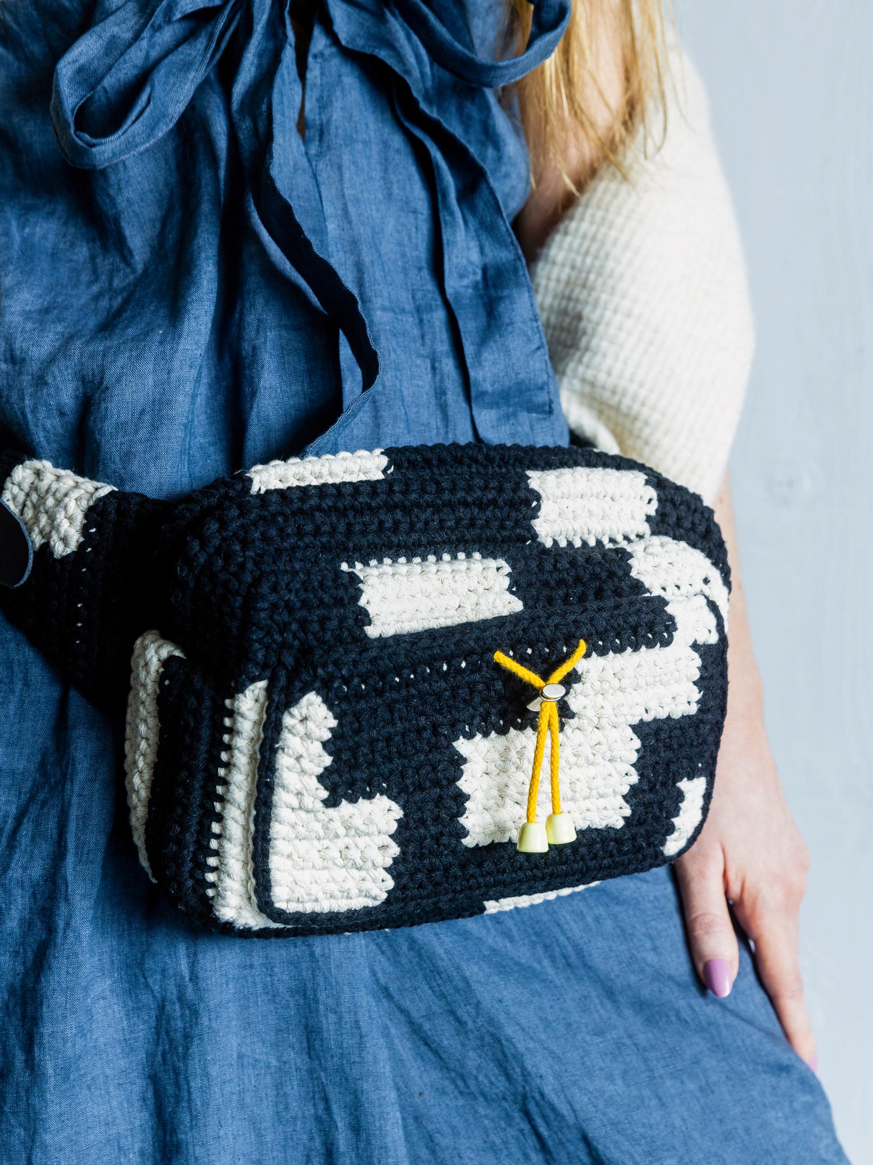 Crochet this roomy belt bag with pattern by Molla Mills—the two-color bag is easy to assemble from pieces