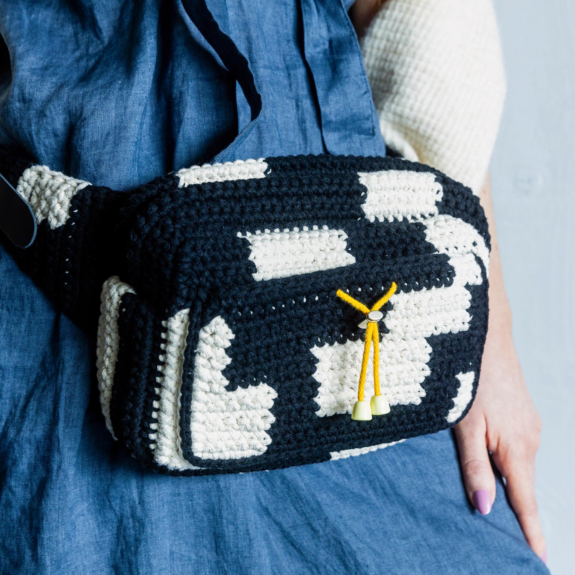 Crochet this roomy belt bag with pattern by Molla Mills—the two-color bag is easy to assemble from pieces