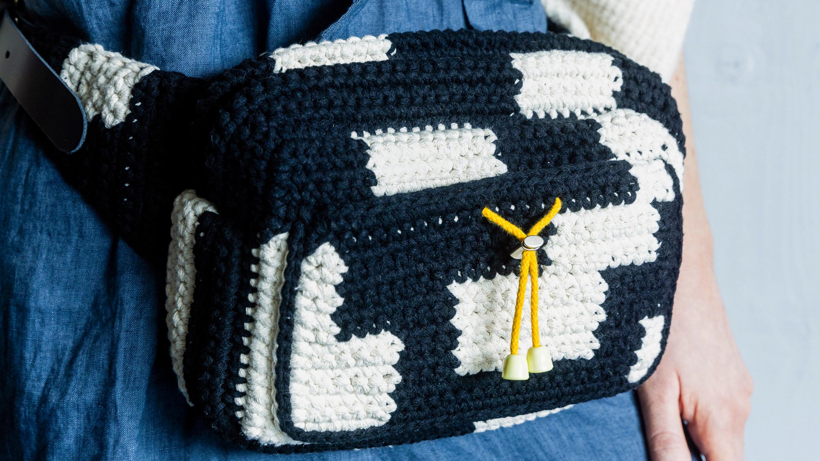 Crochet this roomy belt bag with pattern by Molla Mills—the two-color bag is easy to assemble from pieces