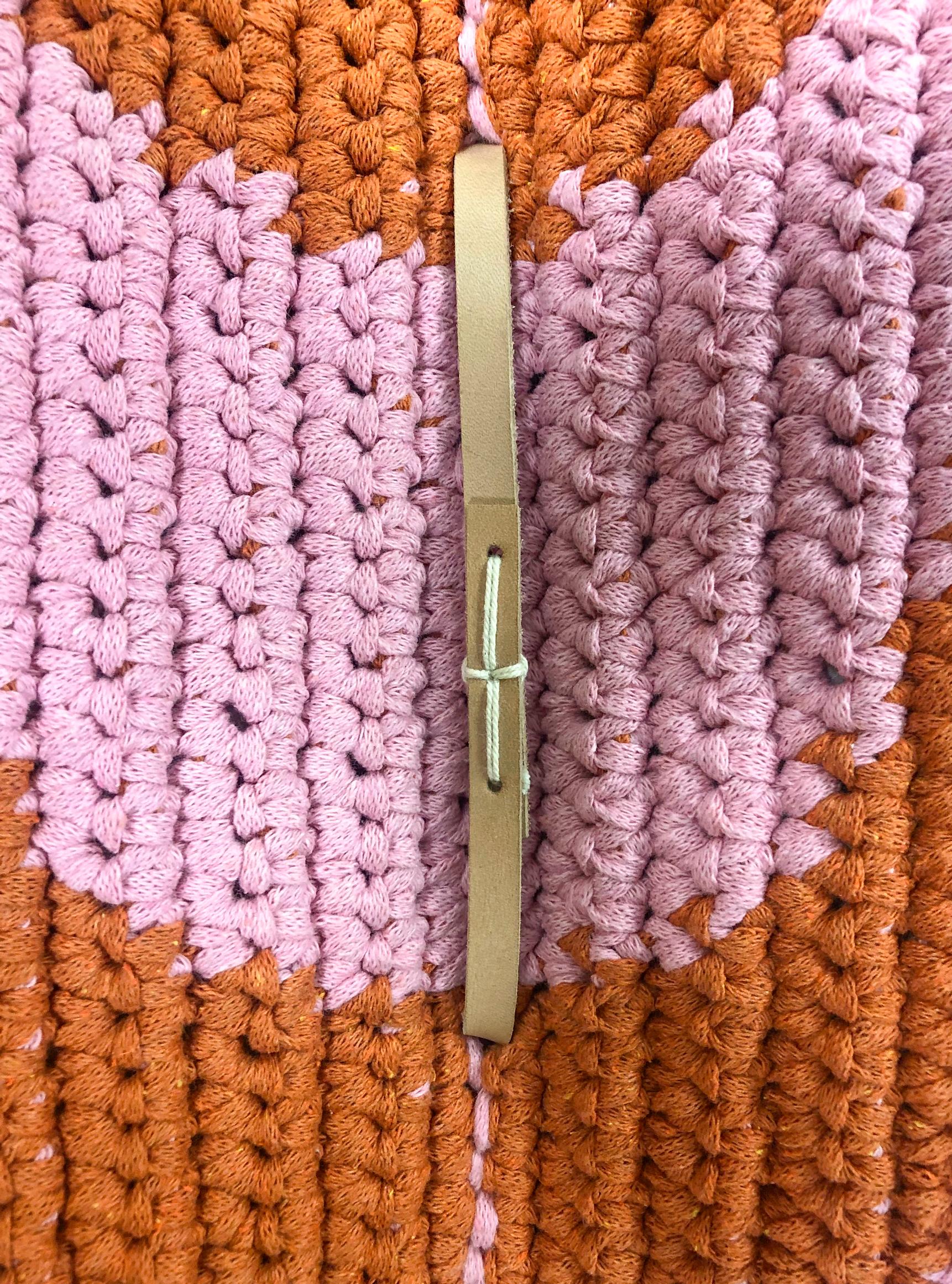 Sewing the handle onto the crocheted foldable cushion