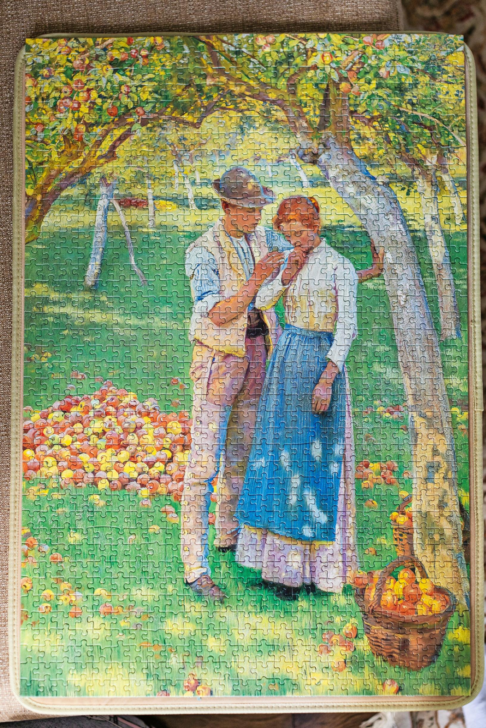 Pictured is a 1,000-piece puzzle from the 1980s featuring The Orchard by English painter and illustrator Nelly Erichsen.