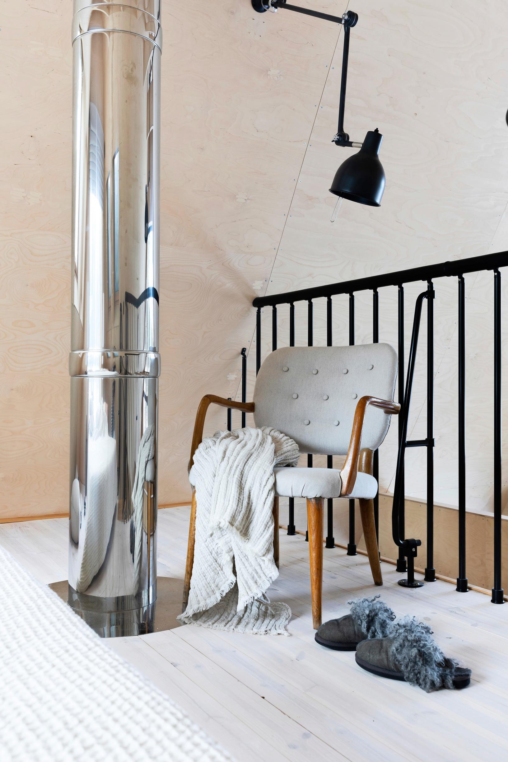 Black metal railing defines the space upstairs