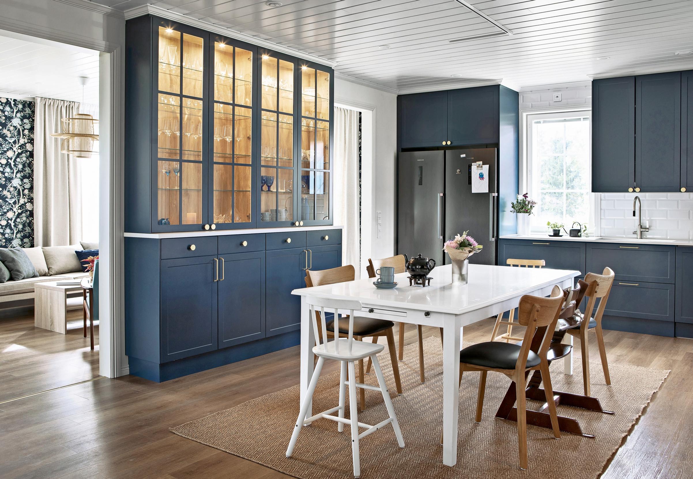 The illuminated display cabinet in the blue kitchen