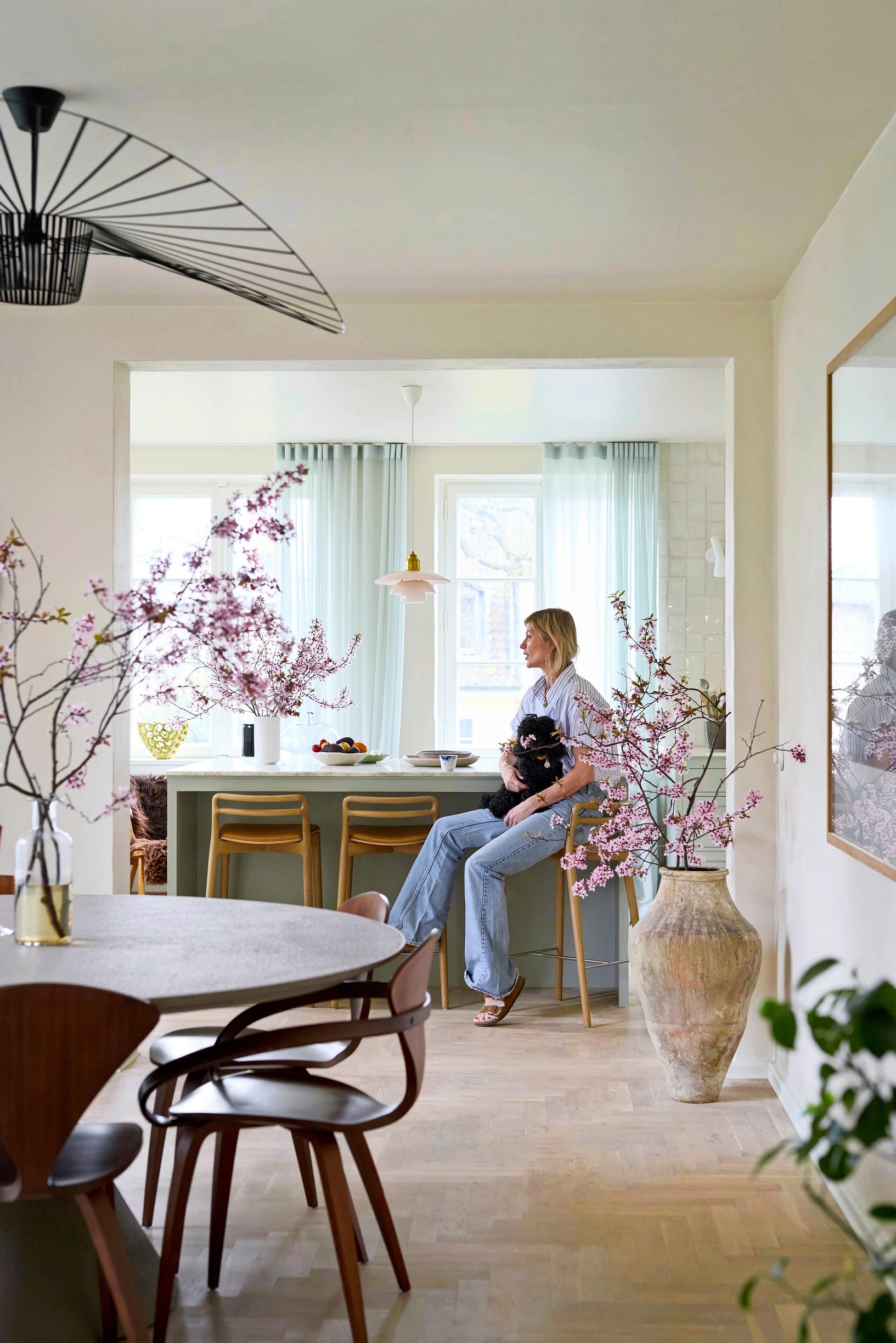 Niina Kurkinen-Nyholm in her kitchen, surrounded by cherry blossoms