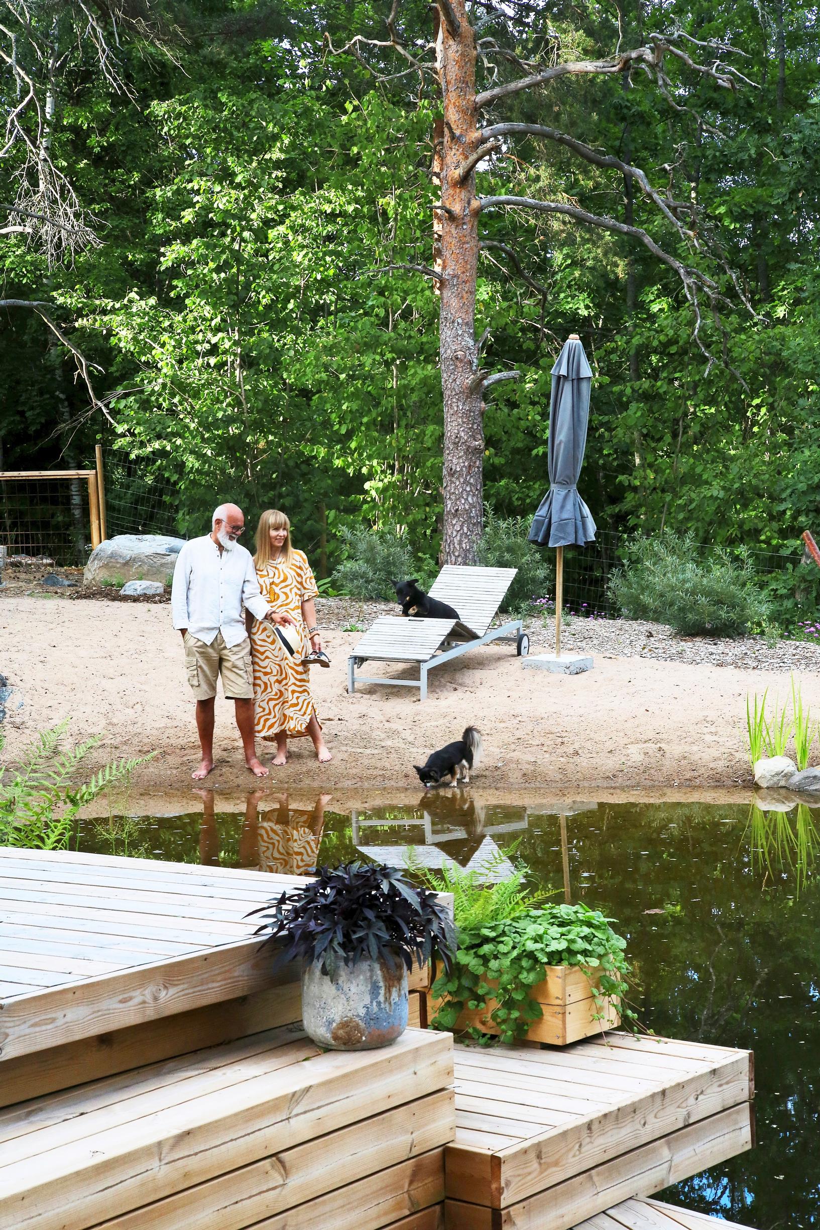 A swimming pond in the yard of a single-family home