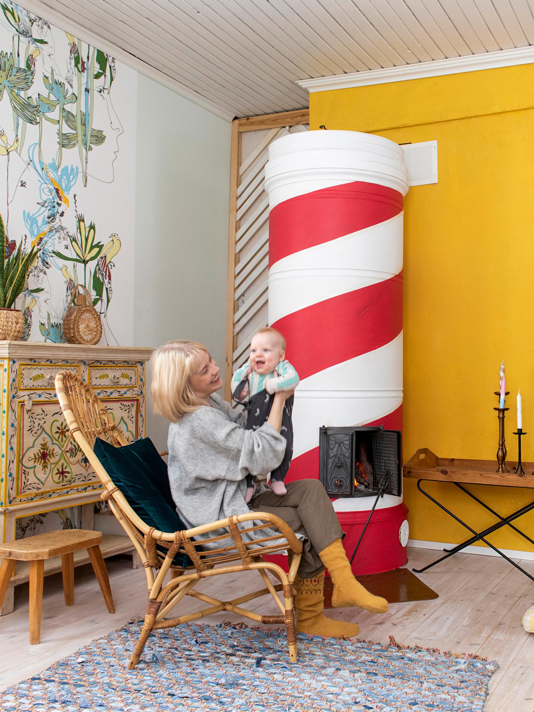 Striped masonry stove transforms living room—the Candy Stove was painted in just 8 hours for 70 euros