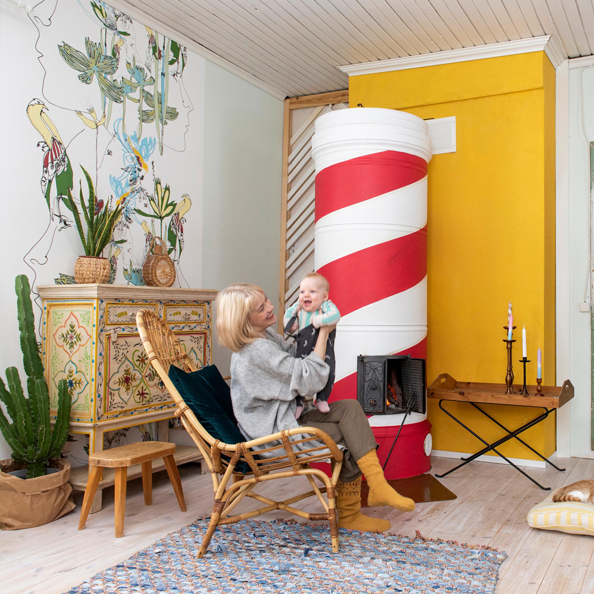 Striped masonry stove transforms living room—the Candy Stove was painted in just 8 hours for 70 euros