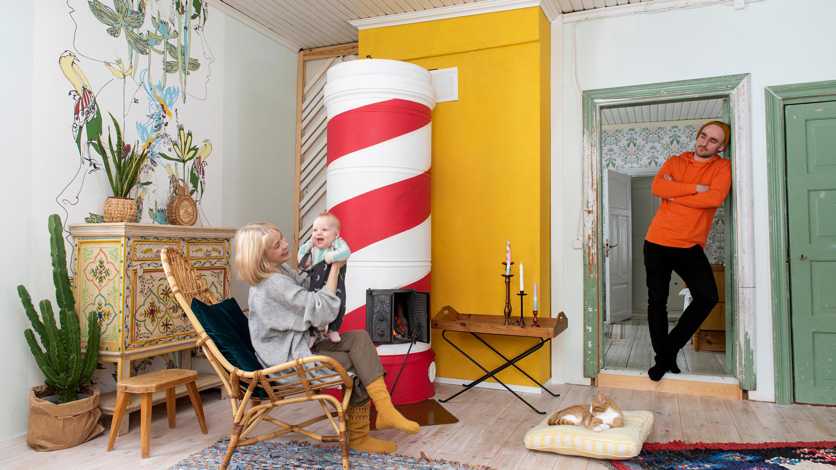 Striped masonry stove transforms living room—the Candy Stove was painted in just 8 hours for 70 euros
