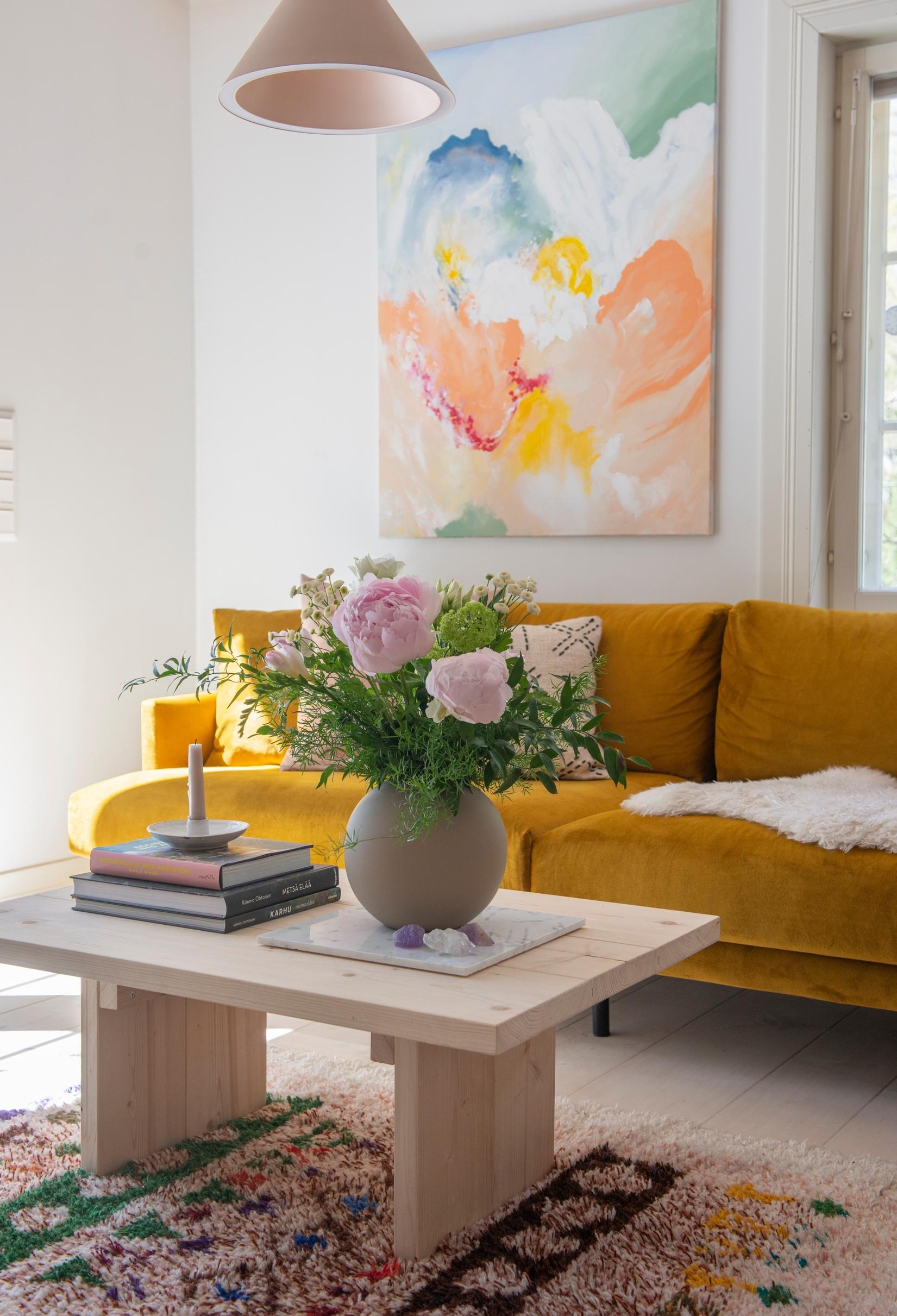 The stylish yet simple coffee table is built from light-colored planks.