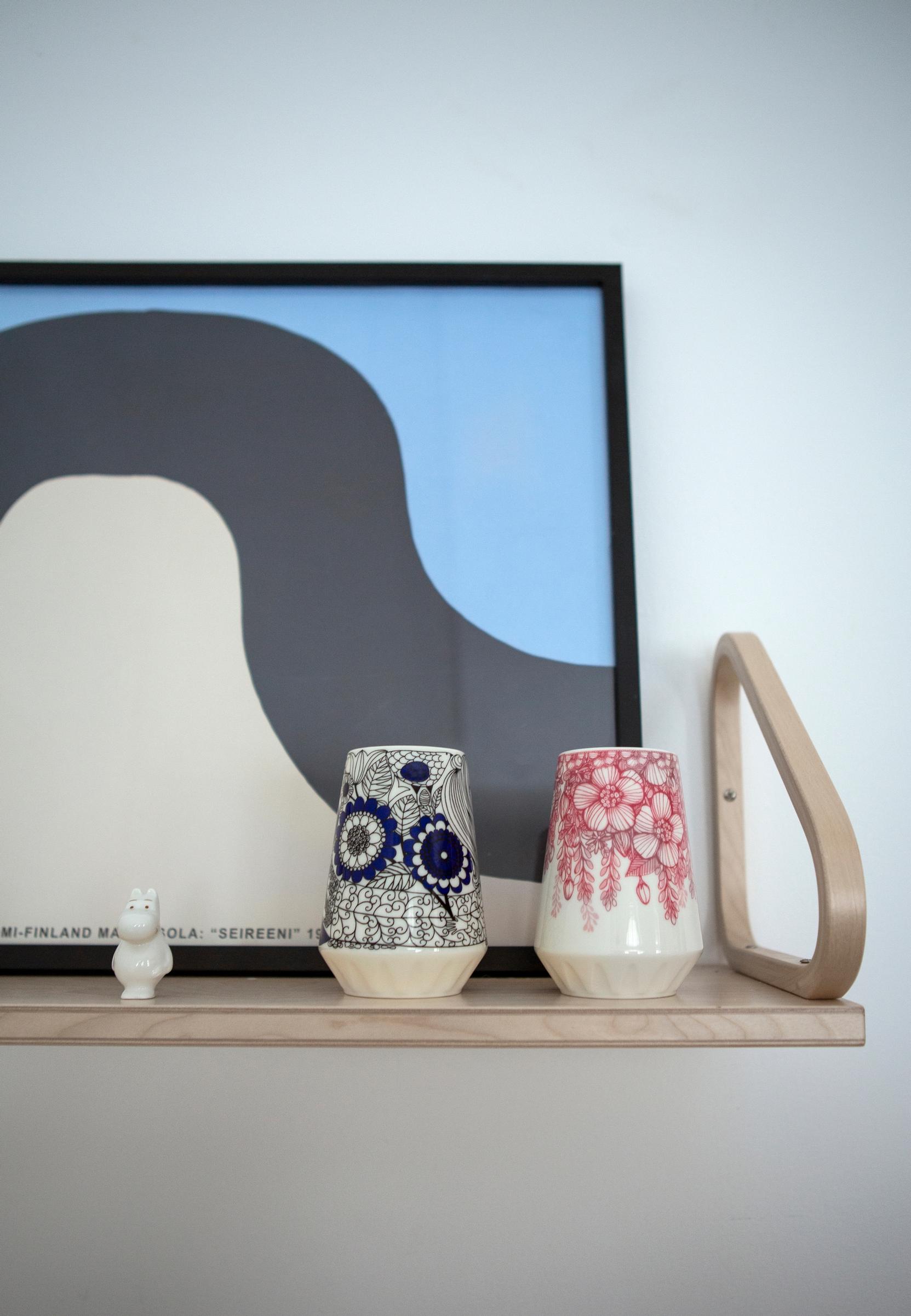 An Artek shelf with Arabia vases and a Moomin figurine