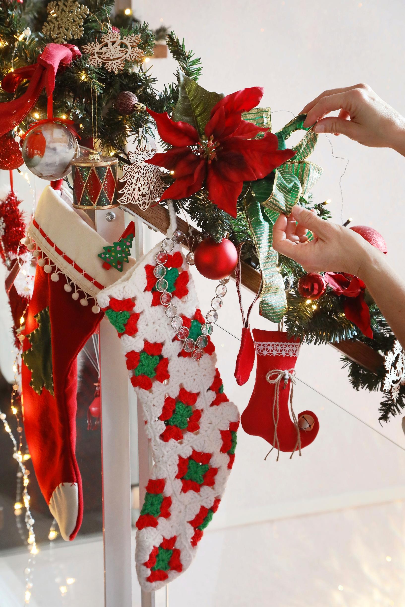 Christmas stockings and a garland on the stair railing.
