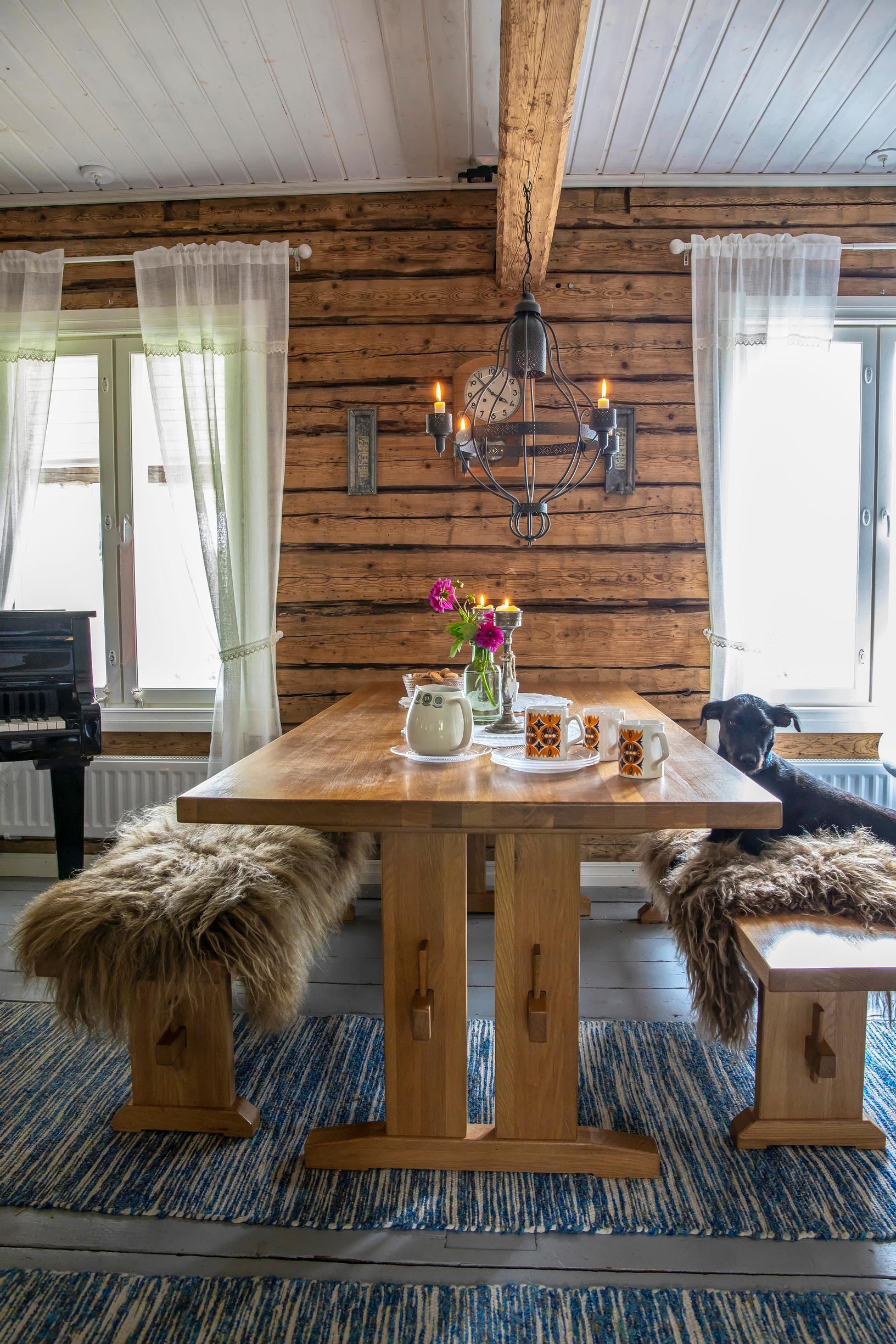 A farmhouse table and hides on the benches