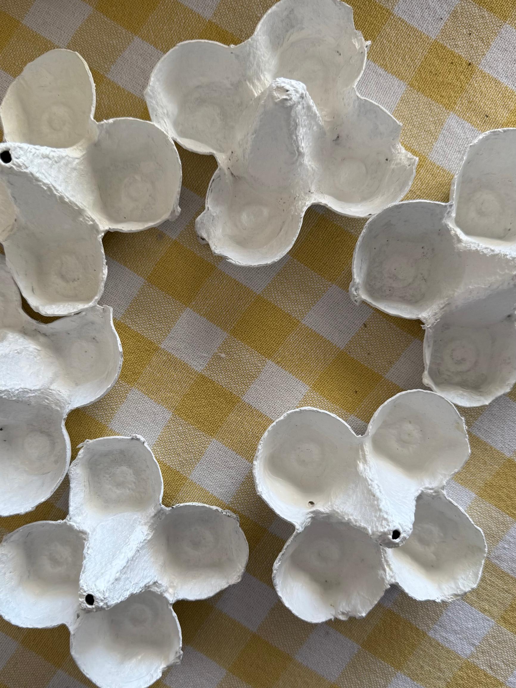 The cut egg carton pieces have been painted white.