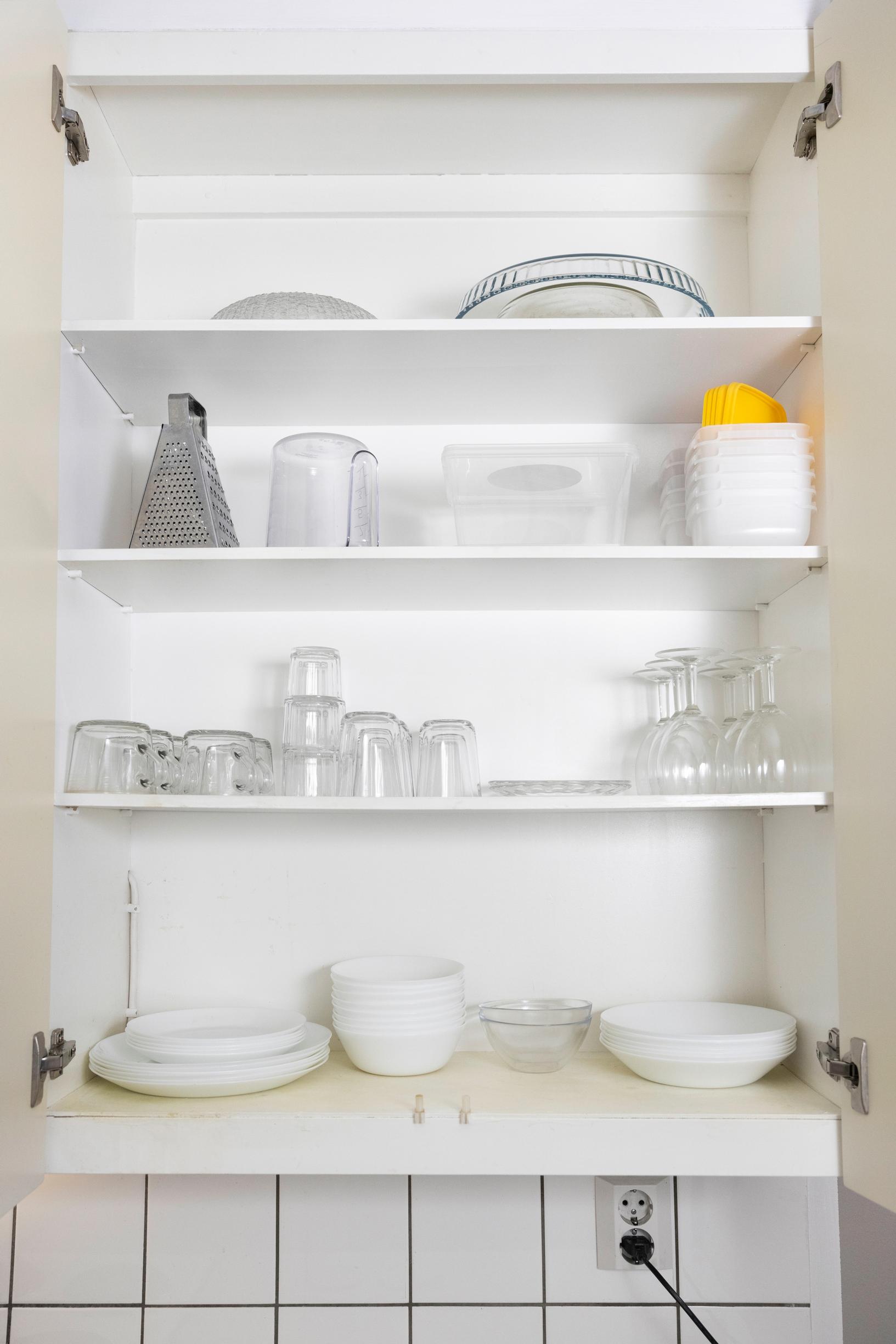 there are a few dishes in the cupboard