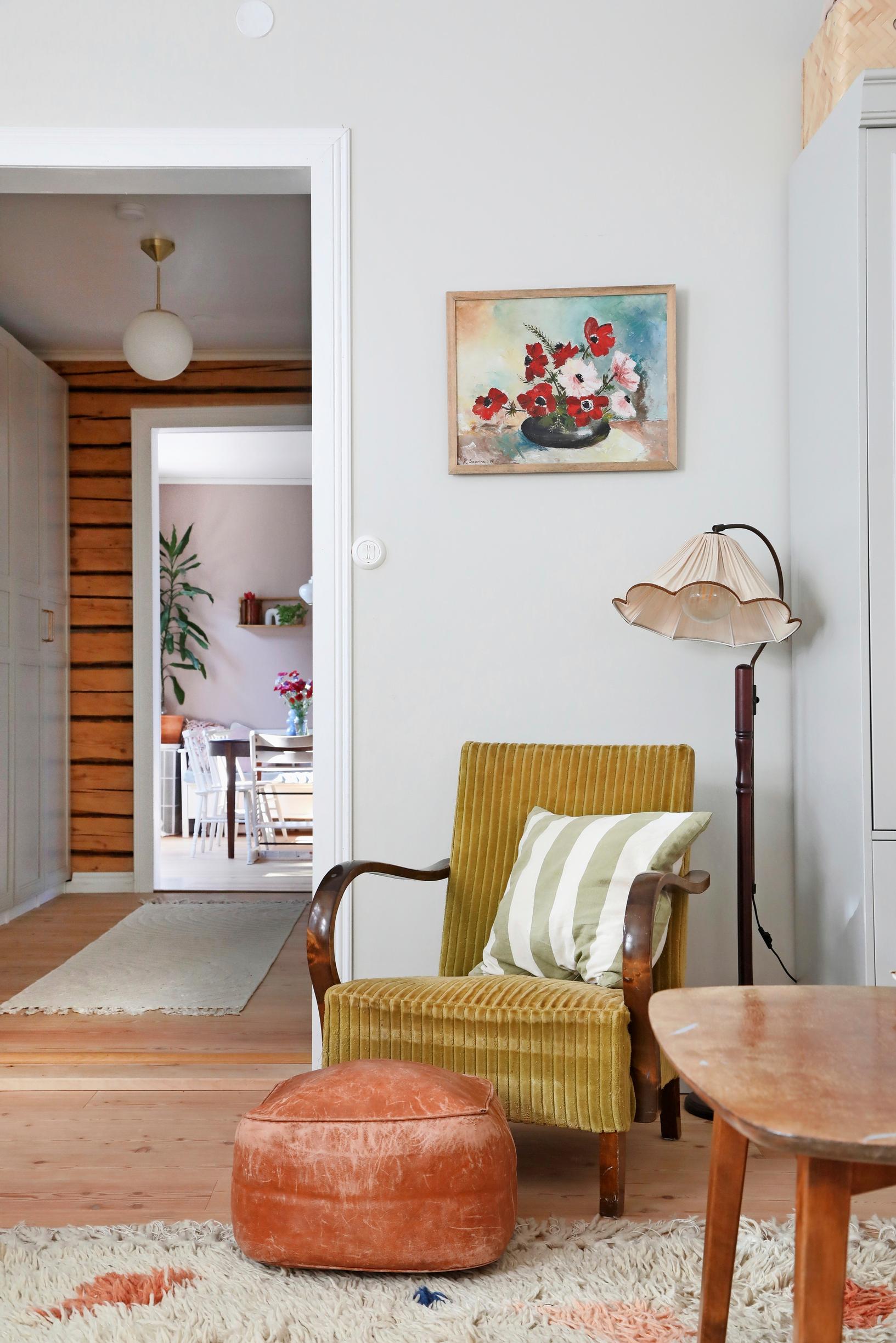 an armchair and an old floor lamp in the living room