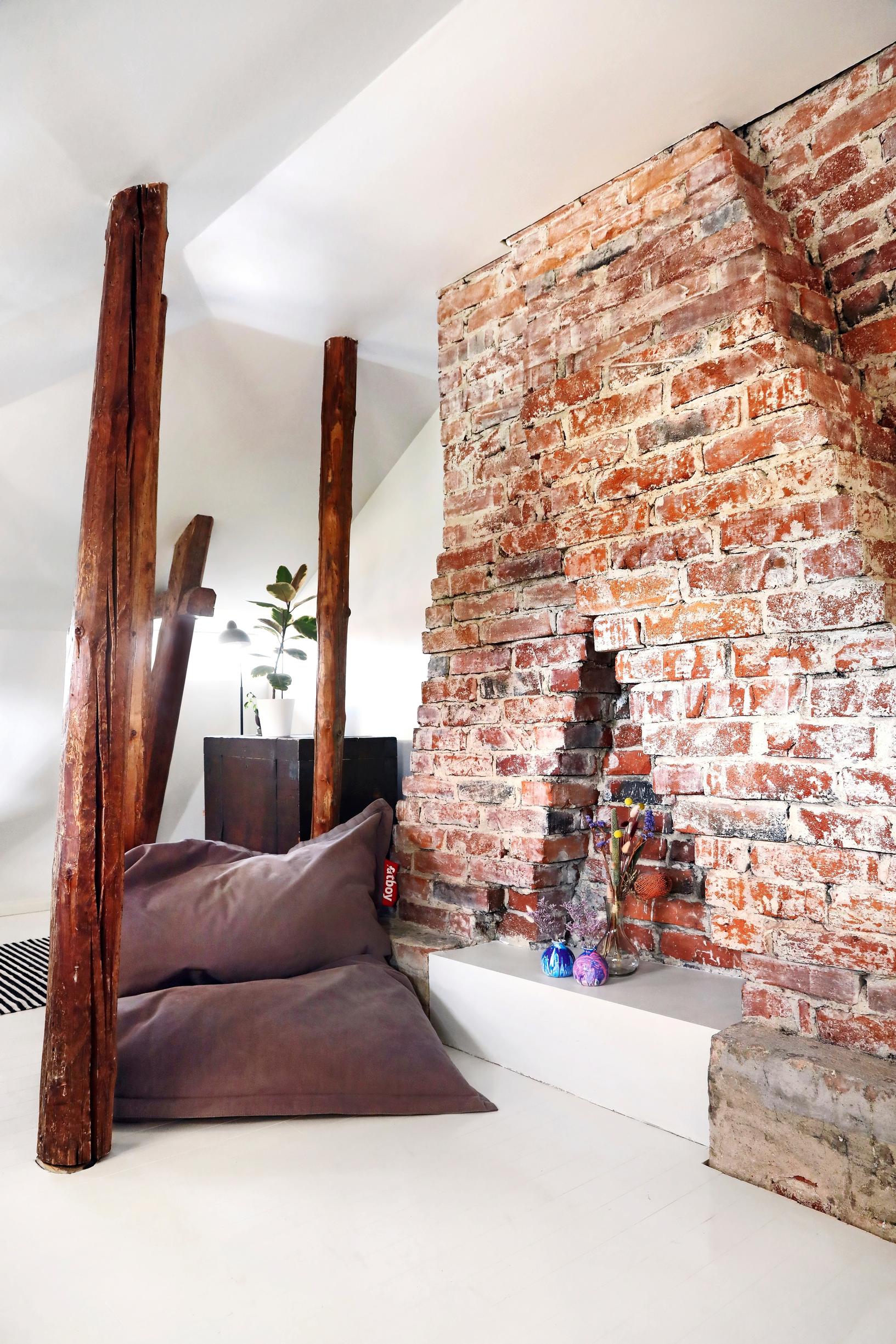 A unified flue structure with a brushed brick surface left visible