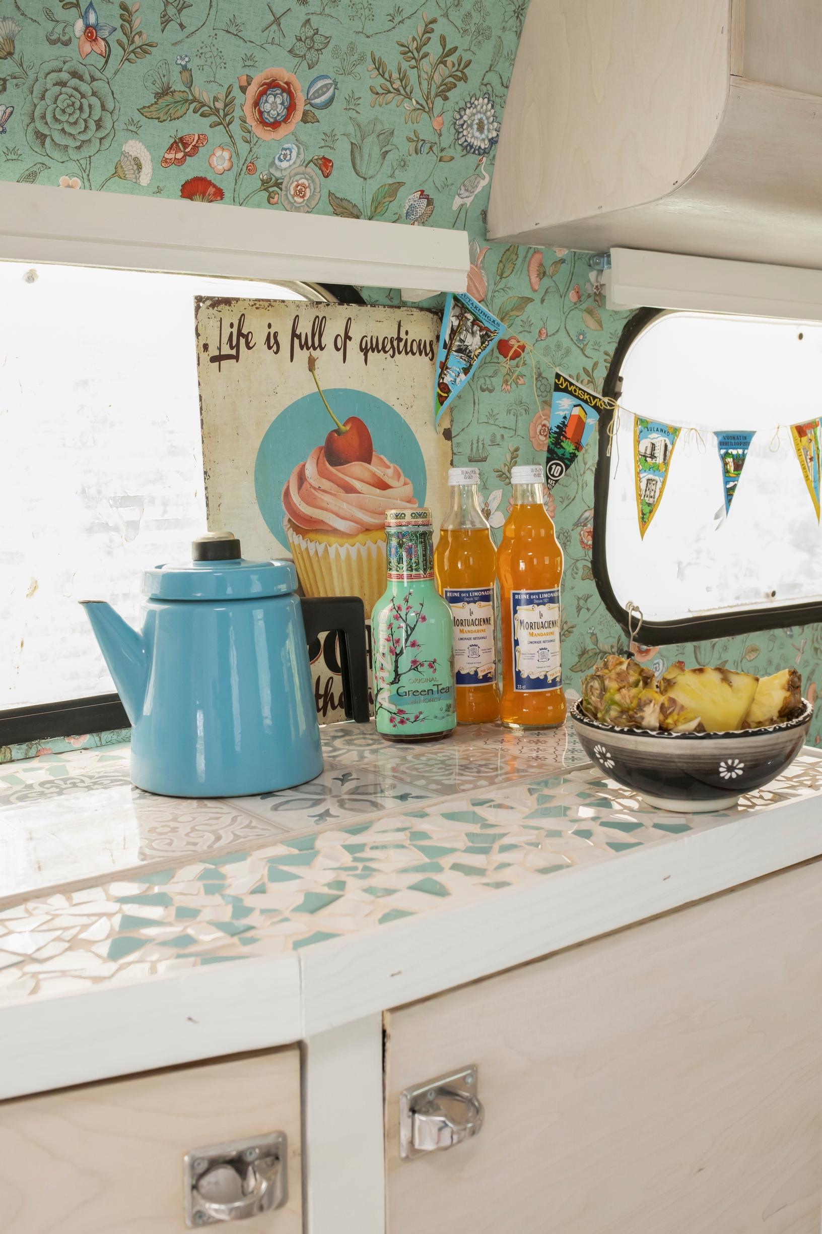 Bottles and a teapot in the caravan’s kitchen