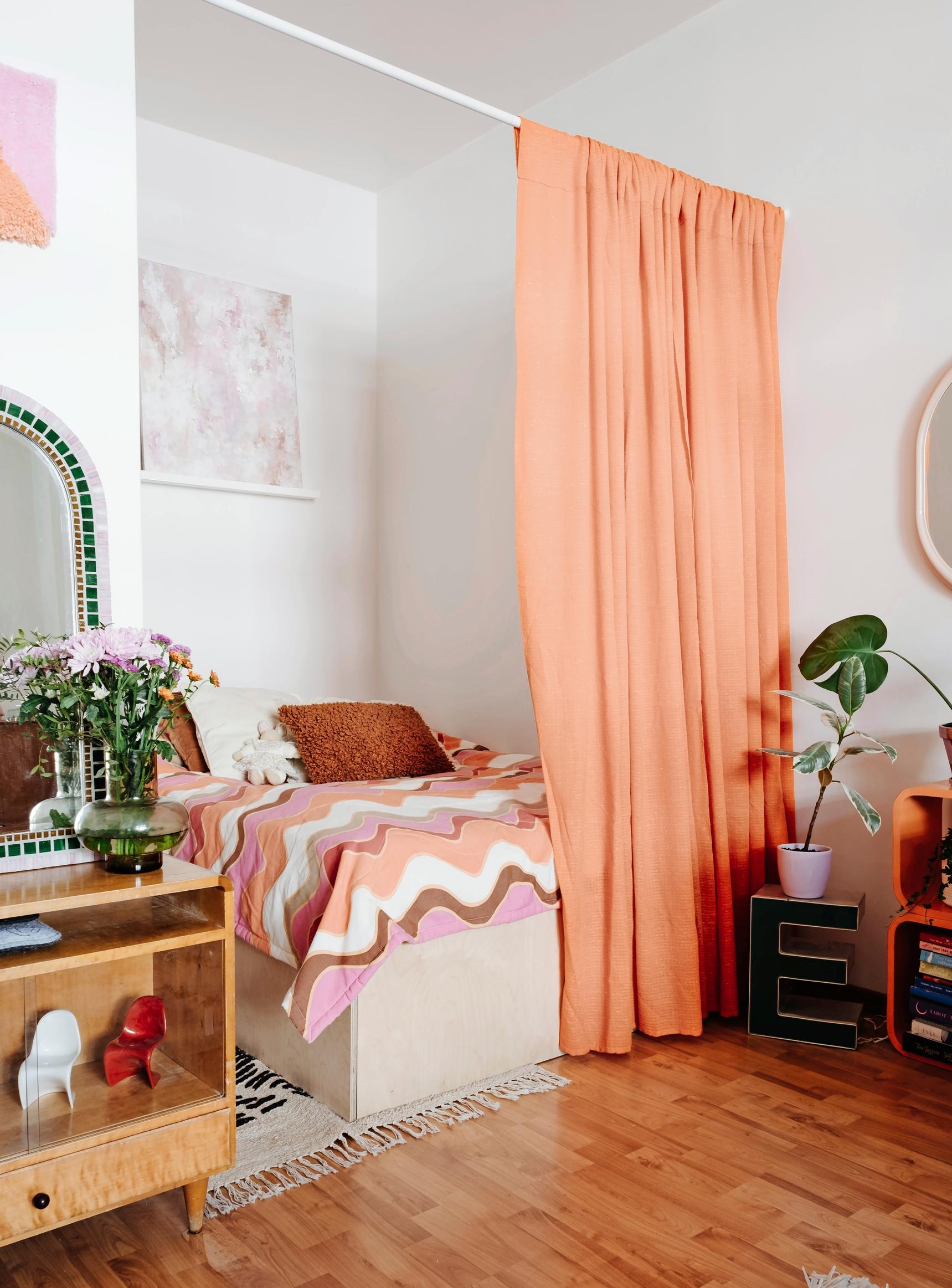 Photo of a studio alcove featuring pink and orange decor.