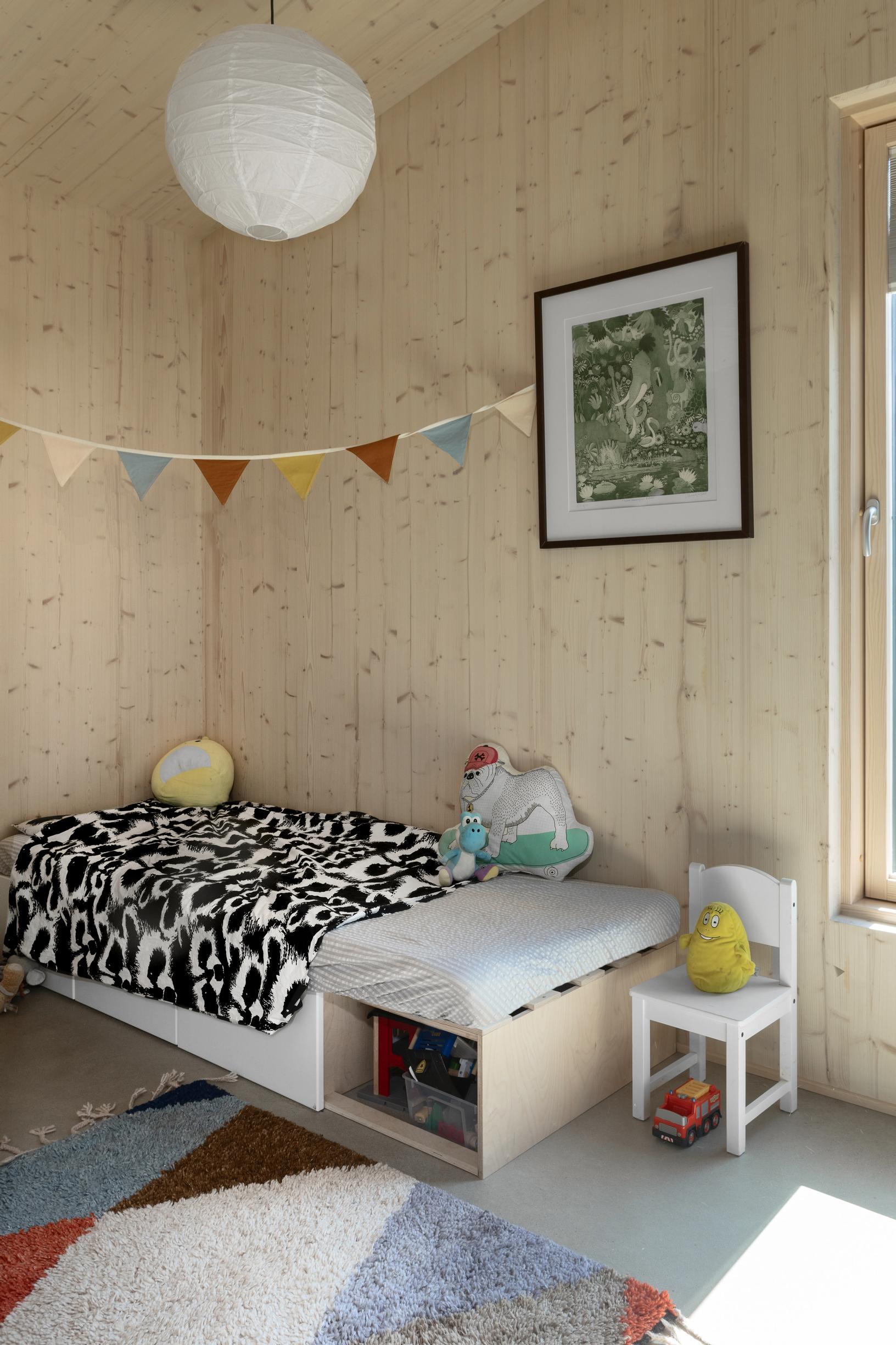 A child’s bedroom with wood-paneled walls