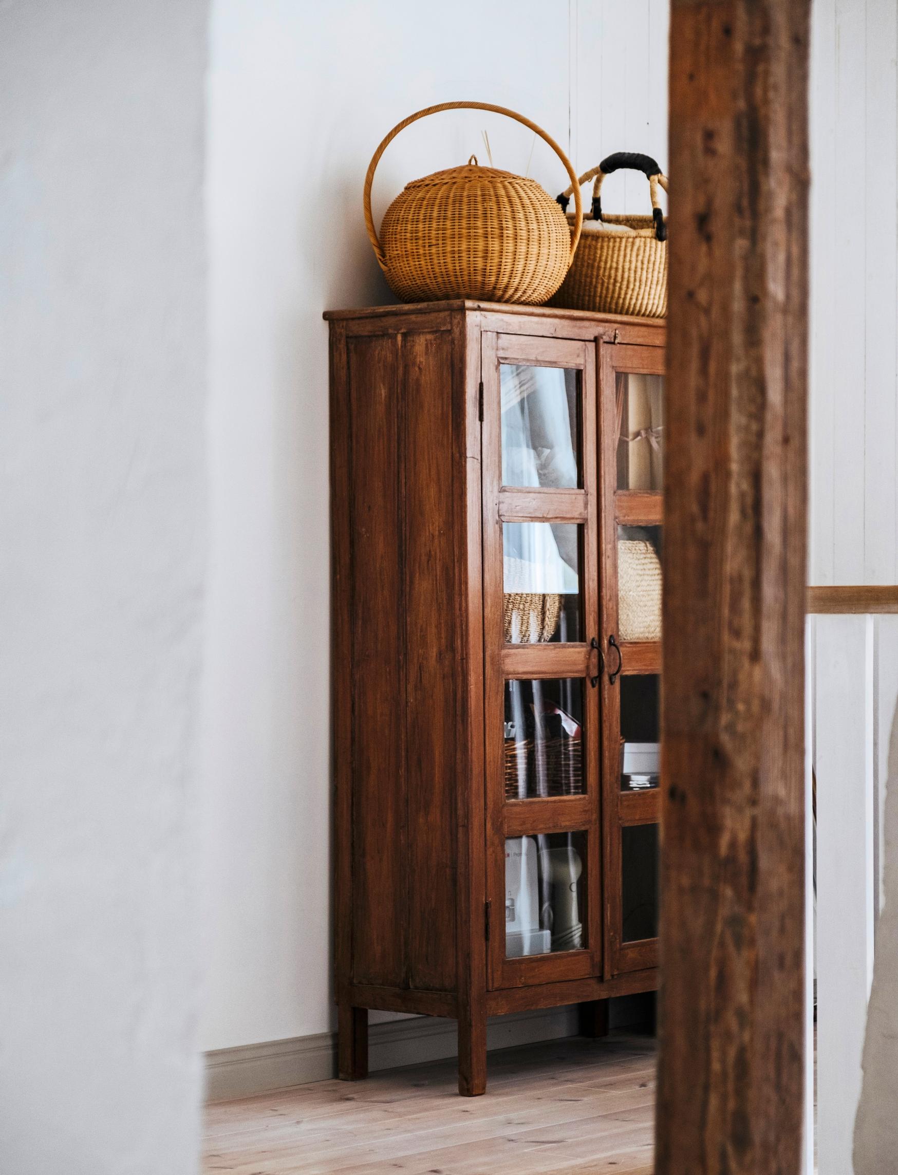 Craft supplies are neatly arranged in an upstairs display cabinet.