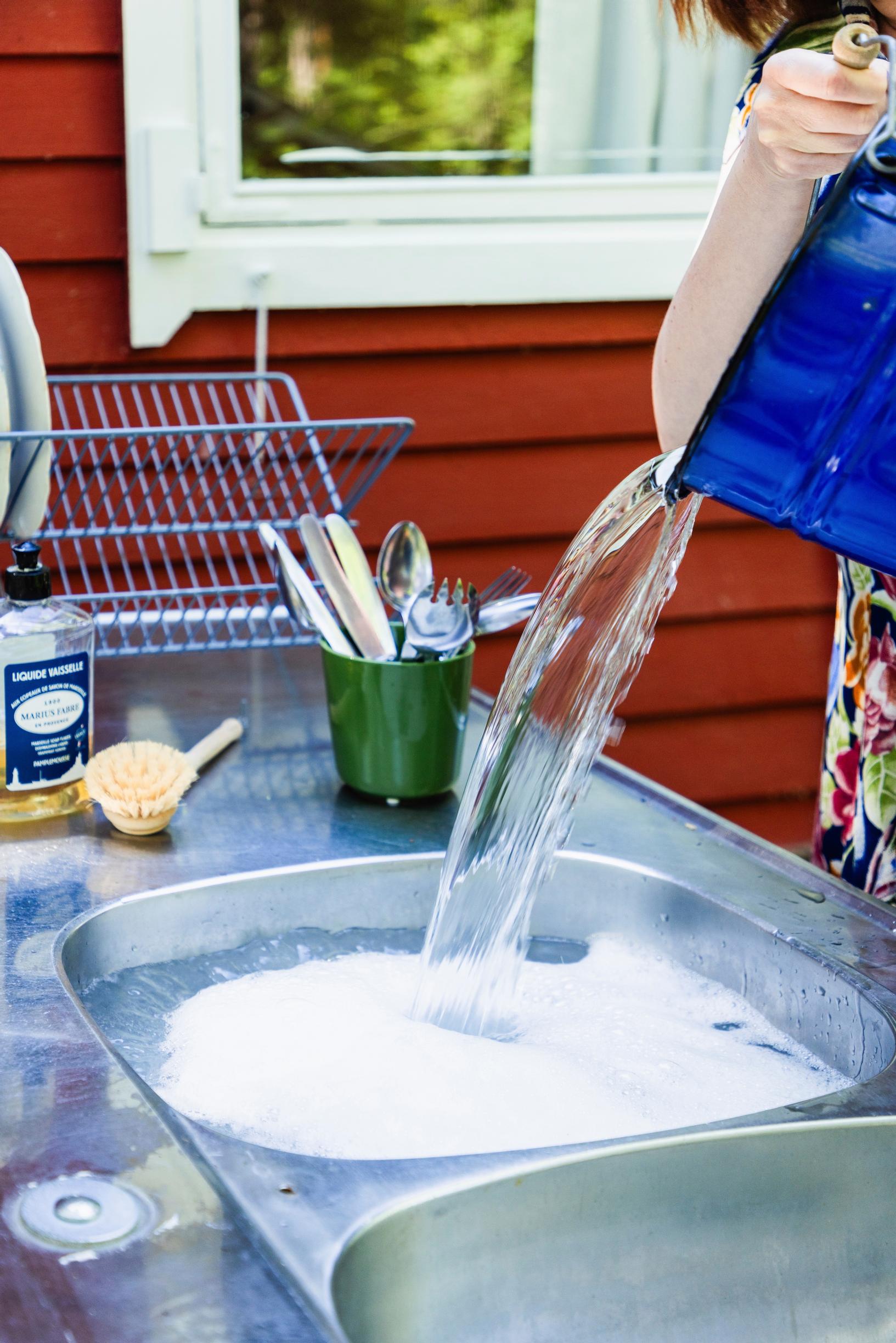 pouring water into an outdoor sink