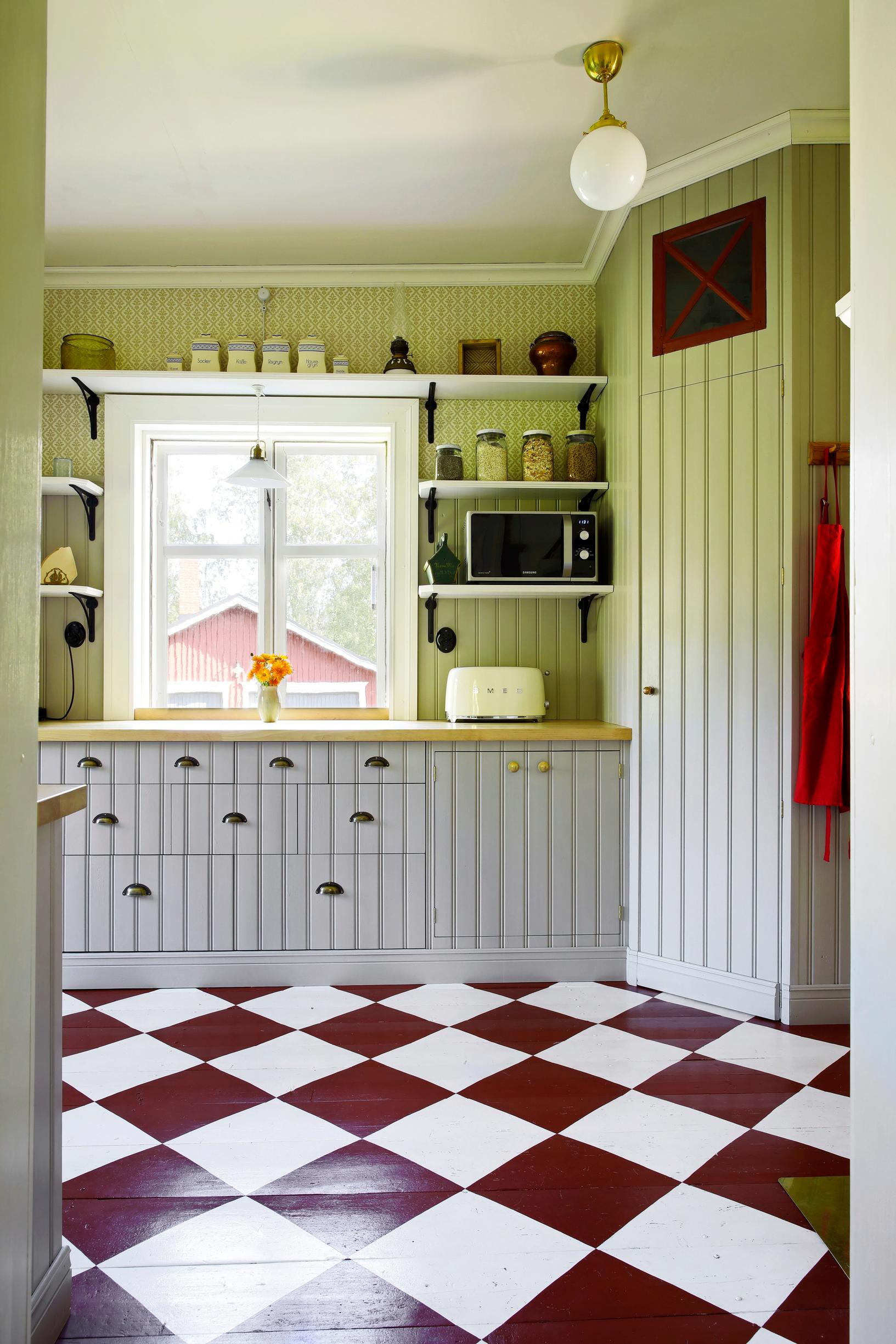 An old house kitchen featuring a pantry and checkered floor