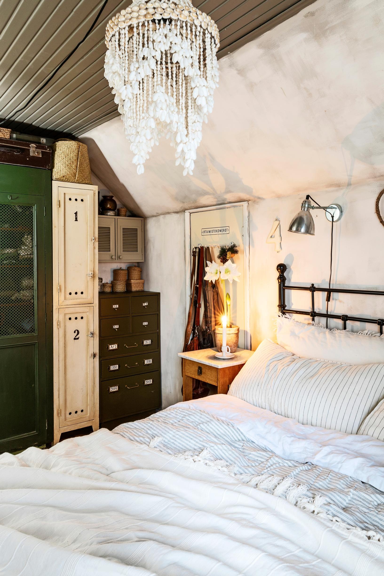 A bedroom in an old house with various cabinets and dressers