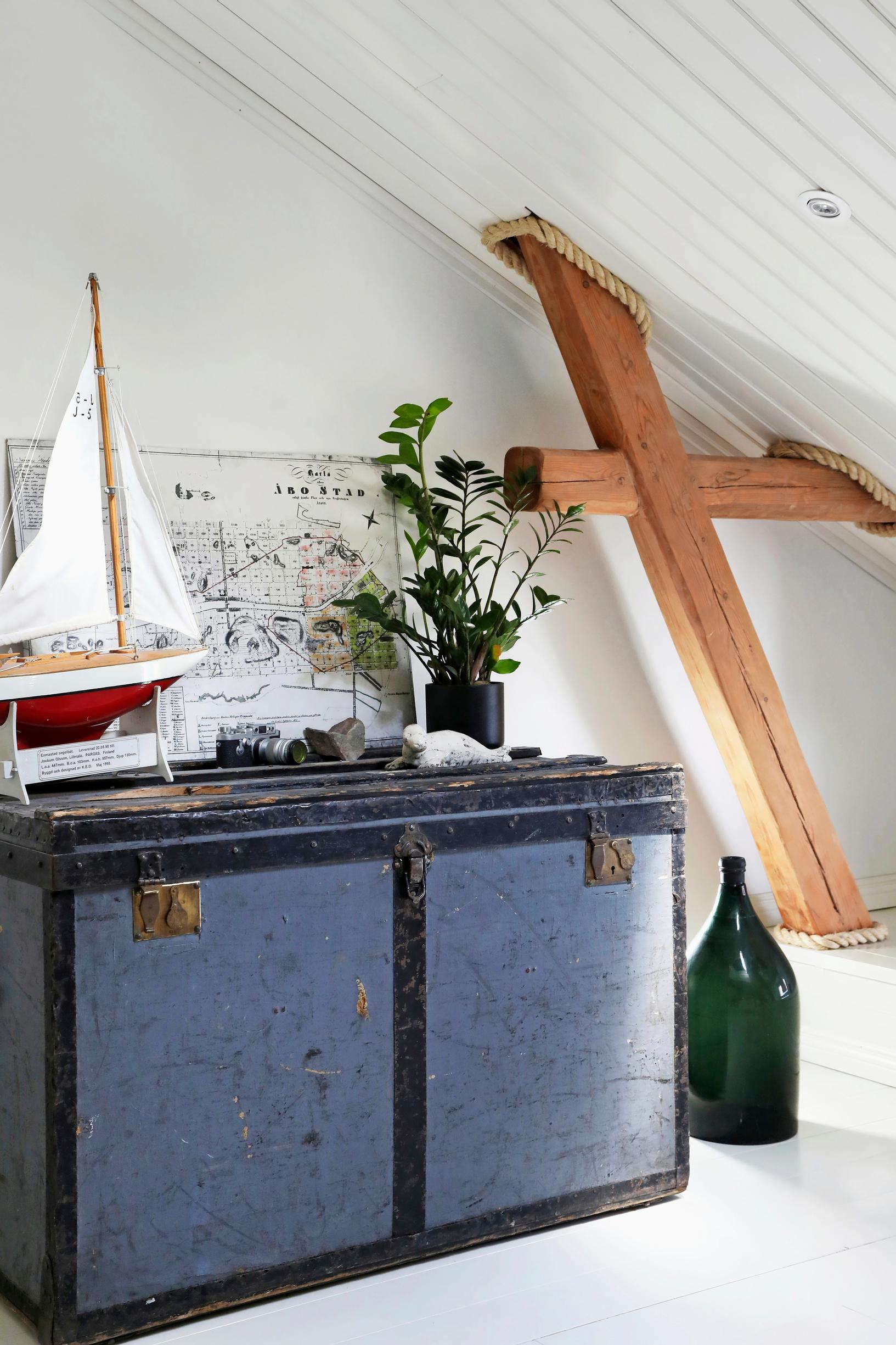 An old trunk with a model sailboat on it
