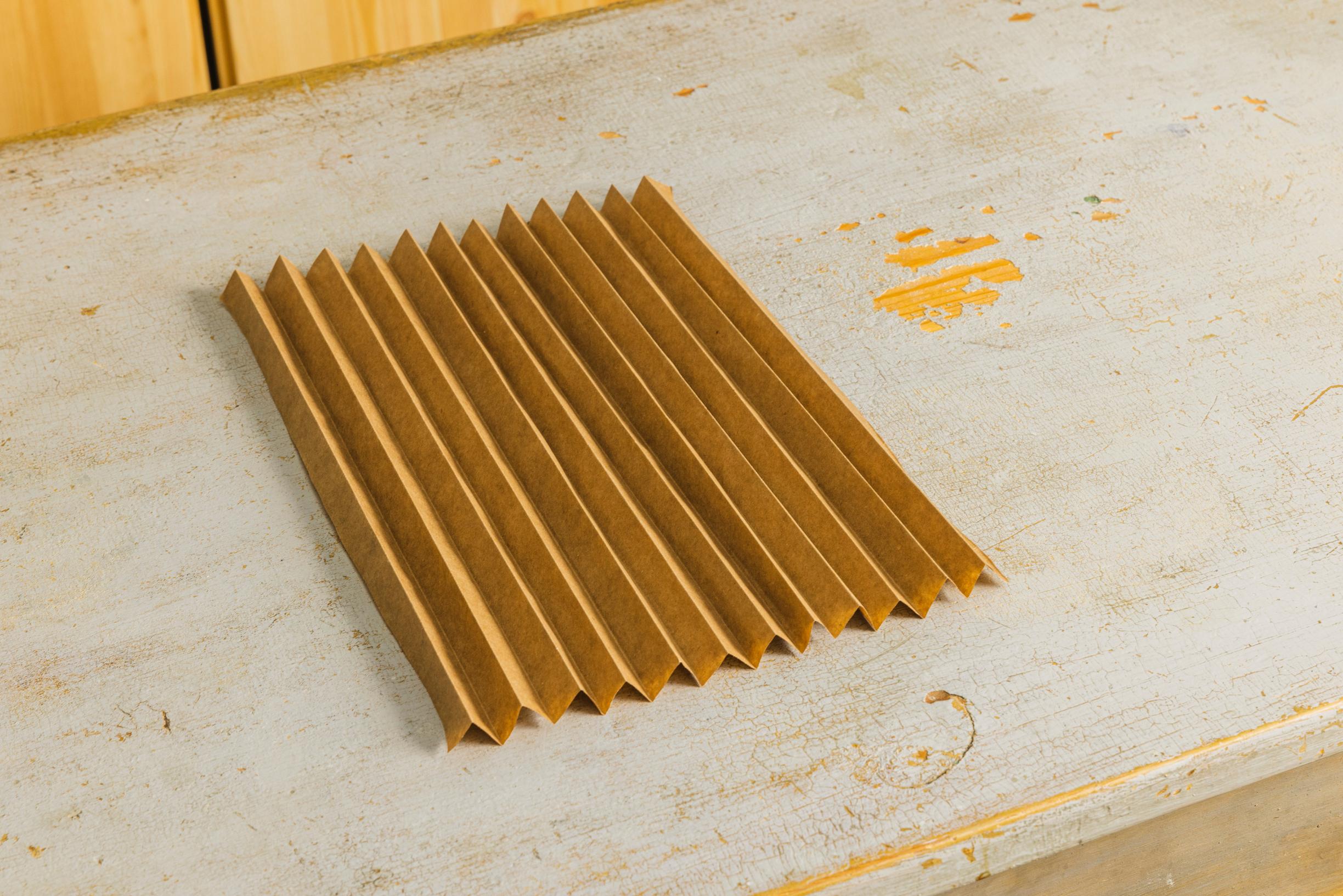 Layered star step 2: kraft paper folded into a tight accordion.