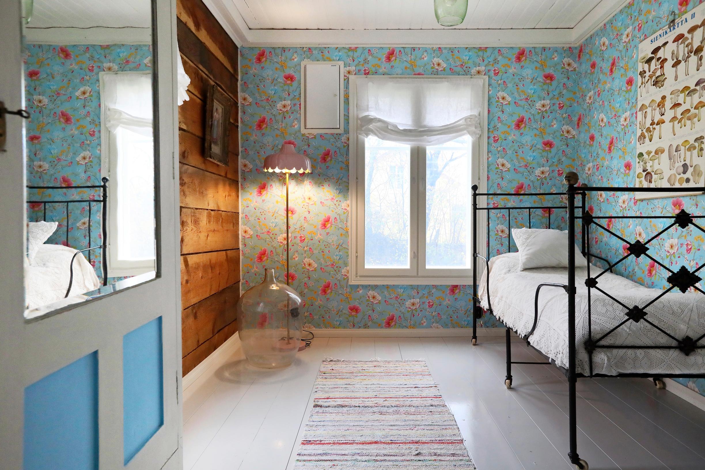 The guest room’s iron bed and Pip Studio wallpaper.
